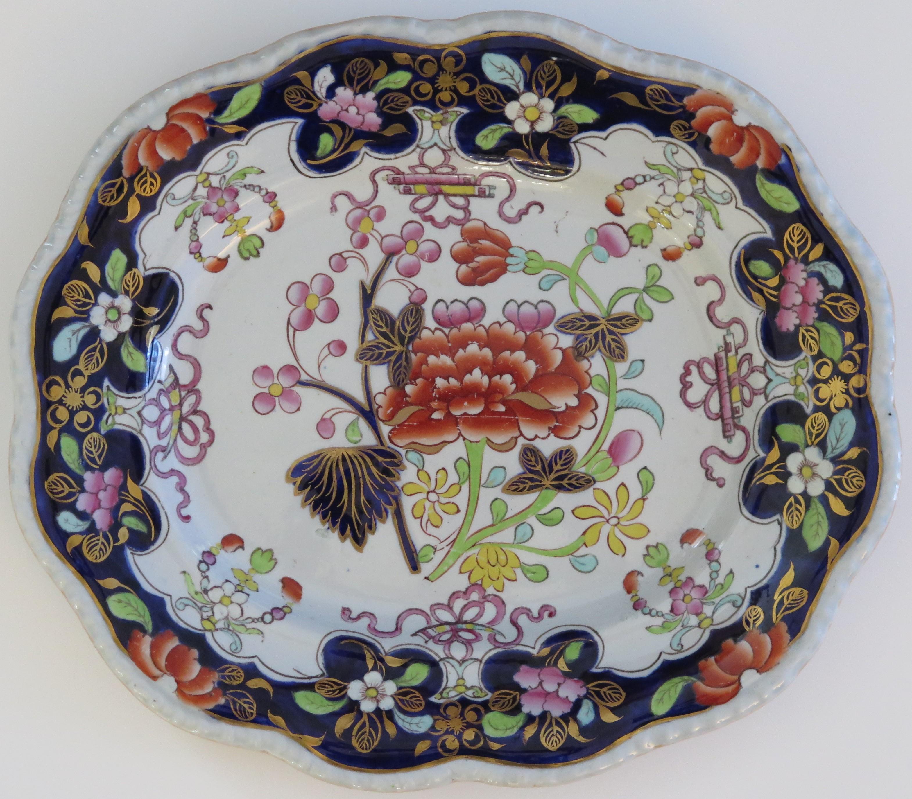 This Ironstone pottery Platter was made by the Mason's factory at Lane Delph, Staffordshire, England and is decorated in the Red Peony & Scrolls pattern, dating to the 19th century, Circa 1835.

This is a rare pattern.

The design is one of
