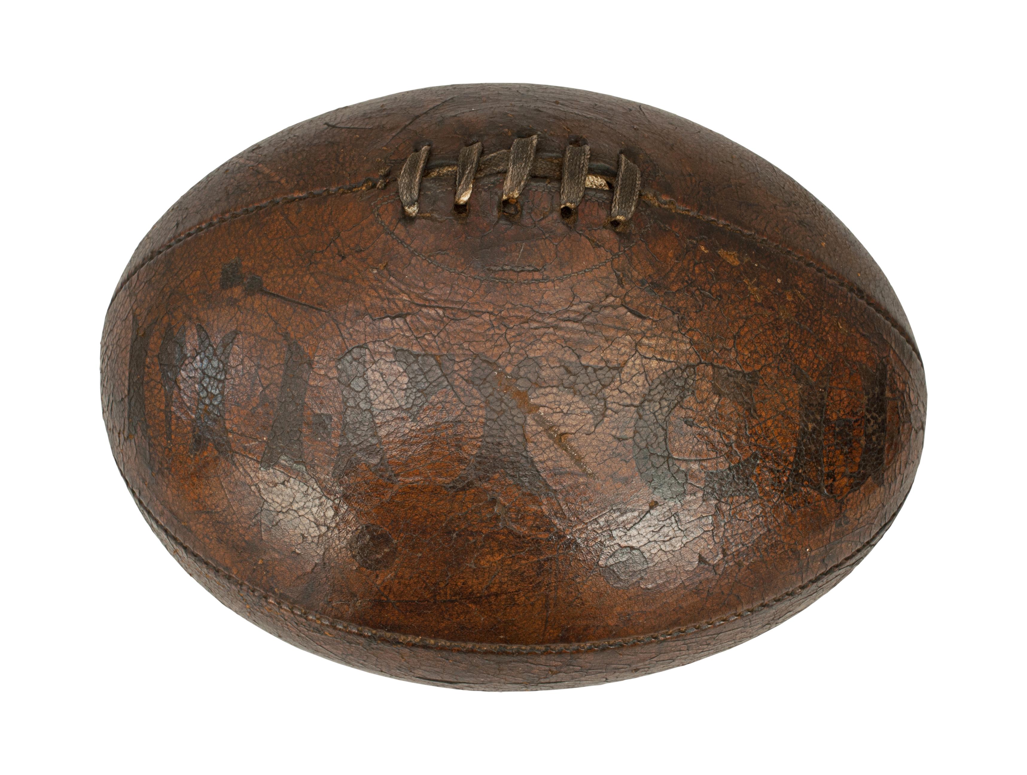 Match leather rugby ball, football.
A very nice, early shaped leather rugby ball with match stencil on one of the panels. The ball is made up of four leather panels and has a lace-up slit to the top to enable bladder inflation.