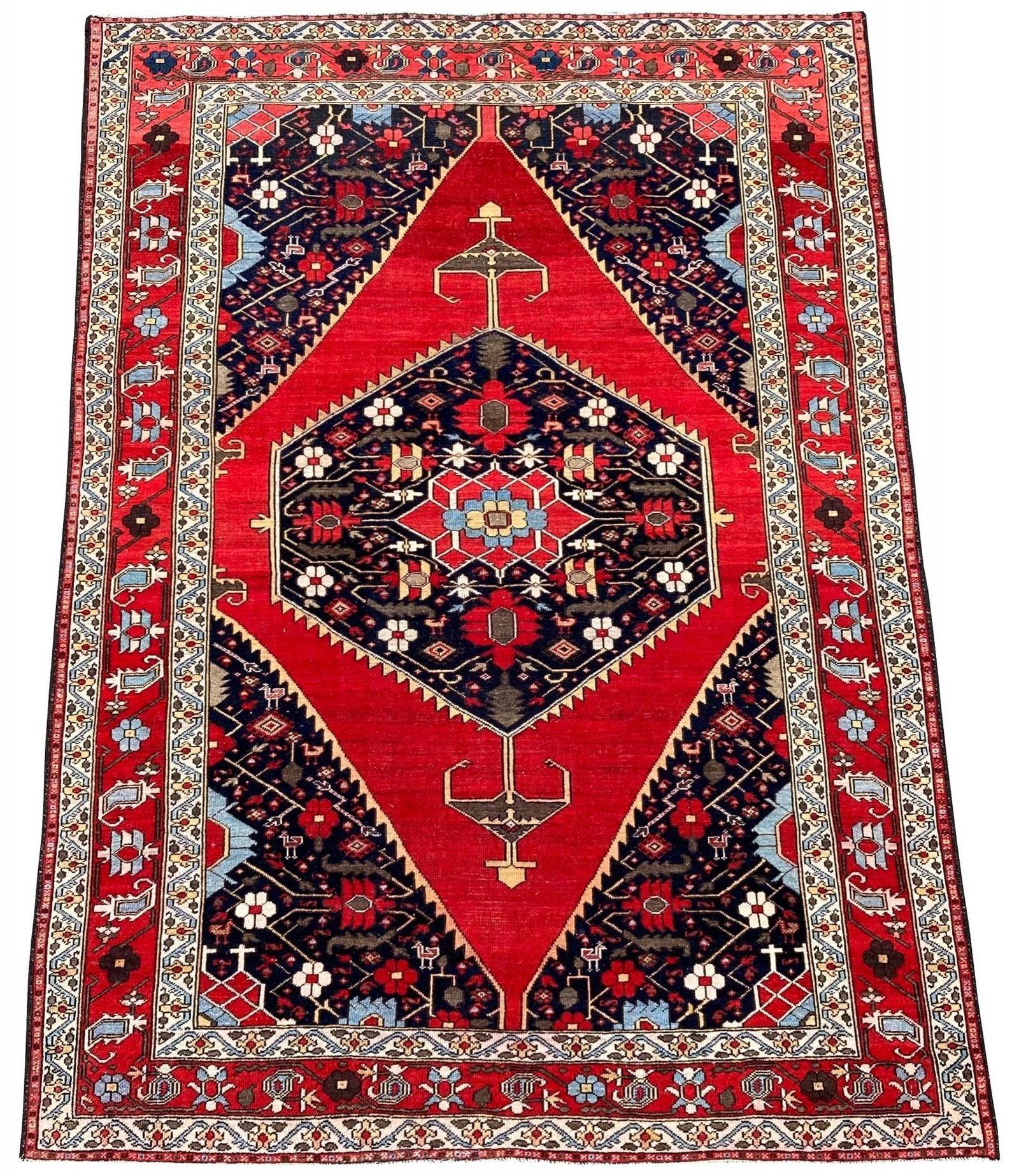 A beautiful antique Mazalagan rug, handwoven circa 1900 with a hexagonal medallion of stylised flowers on a plain red field. Note the small animal motifs in the corner spandrels. Finely woven and lovely wool quality.
Size: 1.87m x 1.41m (6ft 2in x