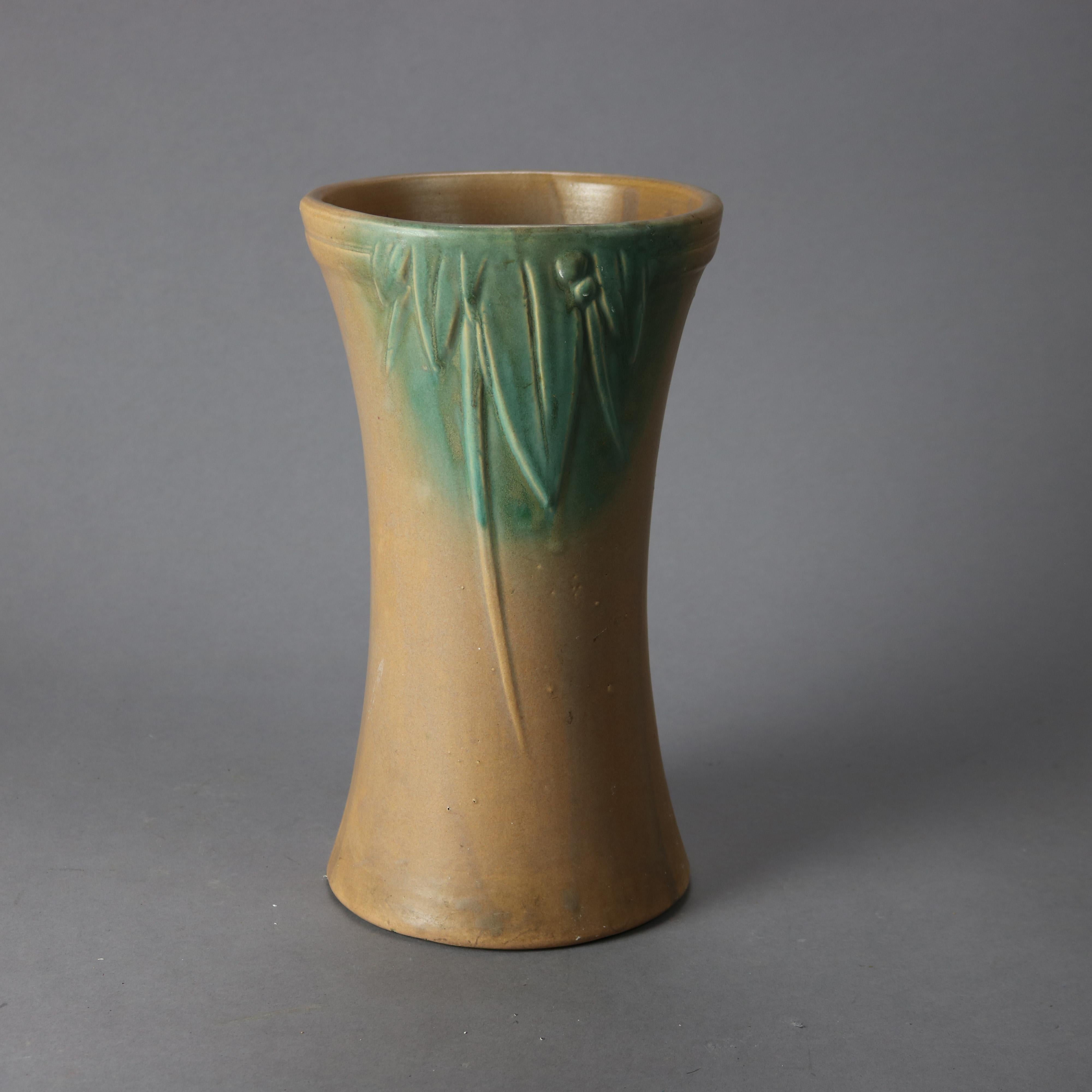 An antique McCoy vase offers art pottery construction with leaf and berry design, circa 1930

Measures - 12.5