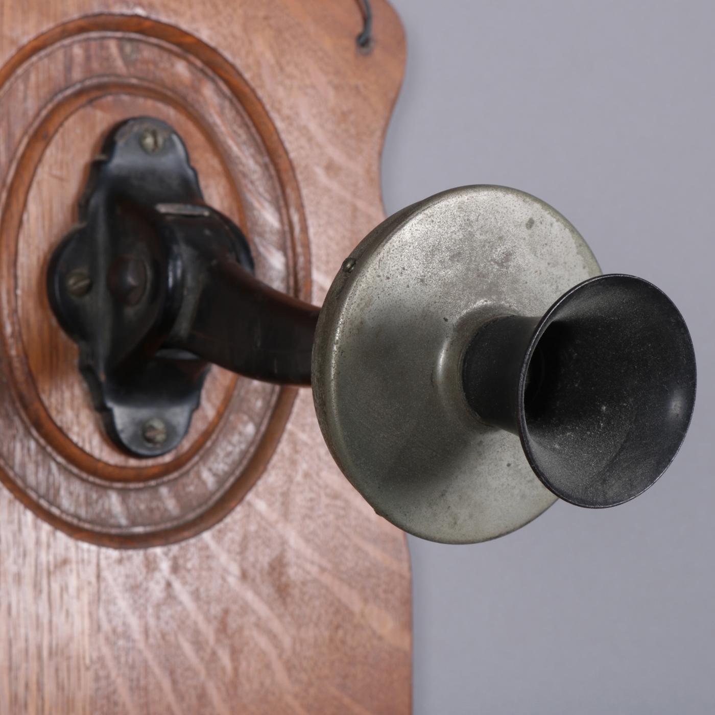 Antique McKinney School wall mount telephone features fiddle back oak case, circa 1890. 

Measures: 25