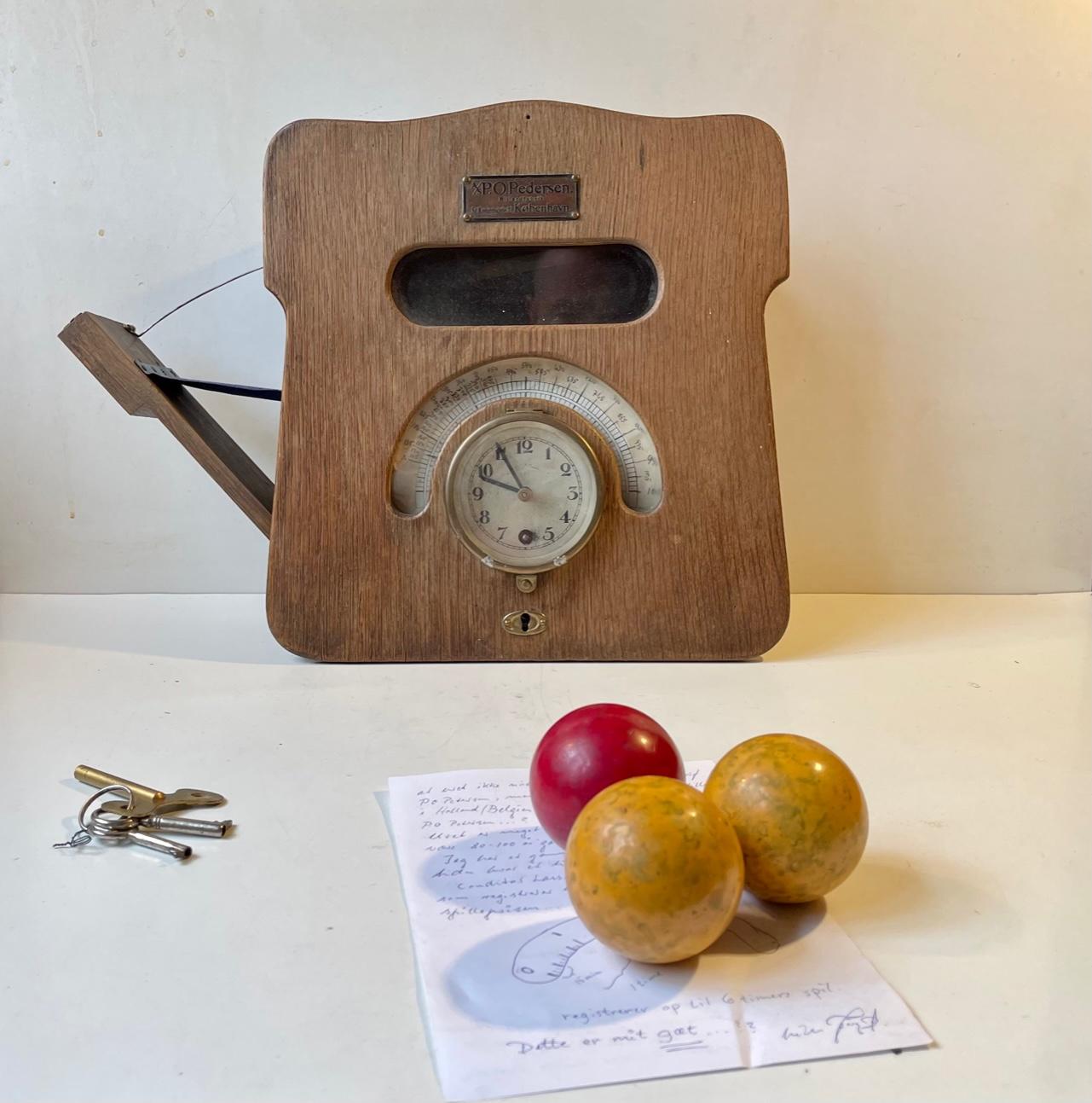 Museum's piece: mechanical clock for 3-cushions billiard. Its is made from oak that has patinated beautiful over the last 100 years. This is how is works. When you remove the 3 billiard balls from their designated key-locked compartment the time