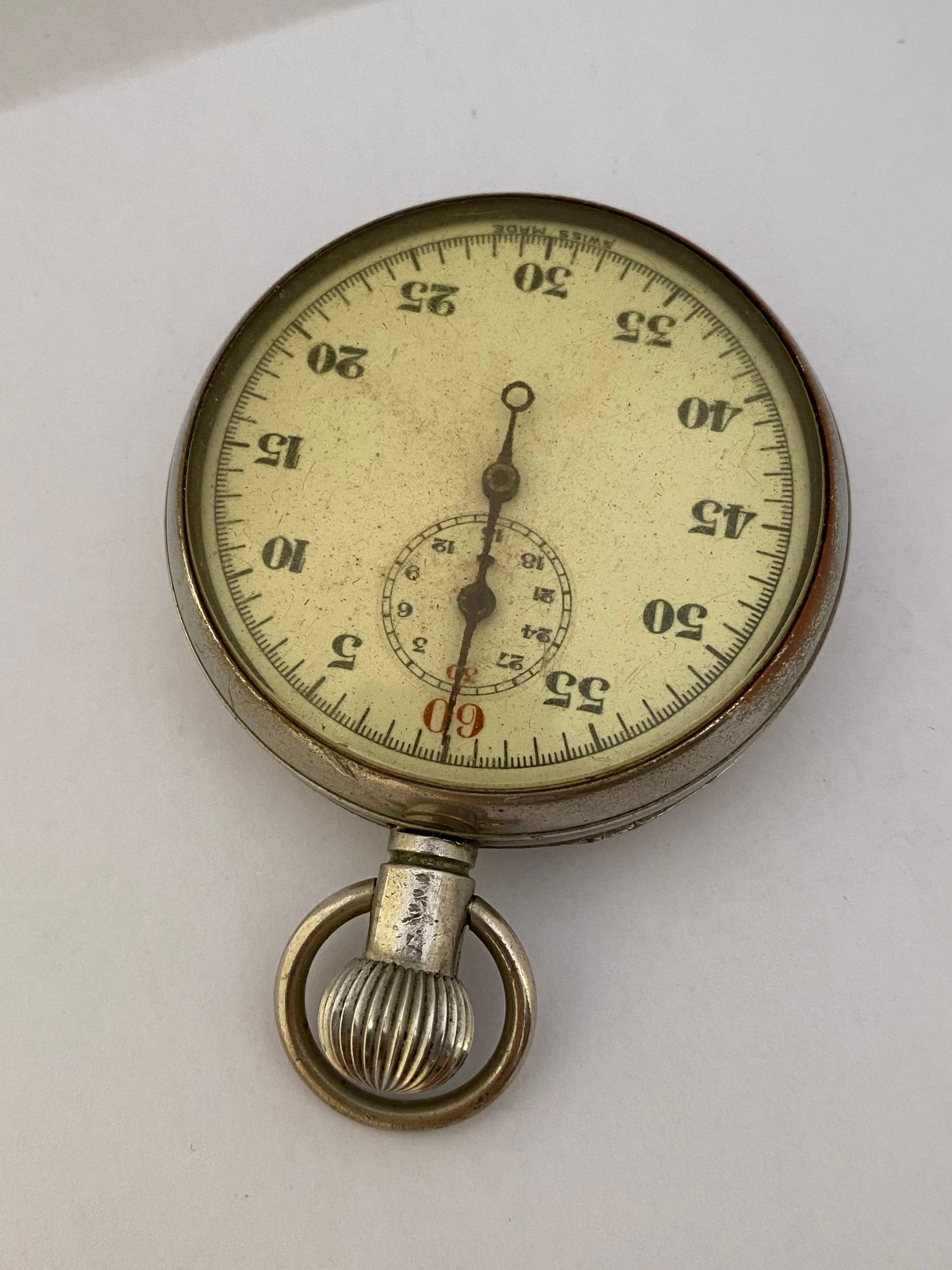 This pre-owned 52mm diameter watch case mechanical stop watch is in good working condition. Visible signs of wearing with light marks on the glass and on the watch case. Some dents on the back case as shown. The watch bessel is a bit tarnished as