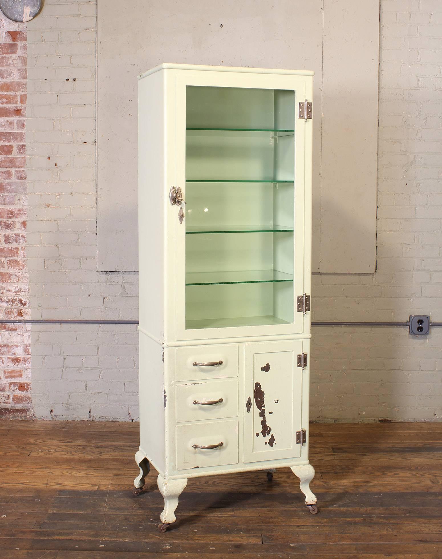 Vintage distressed Doctor's medical display storage cabinet made from steel, metal and glass. Measures 70 1/4