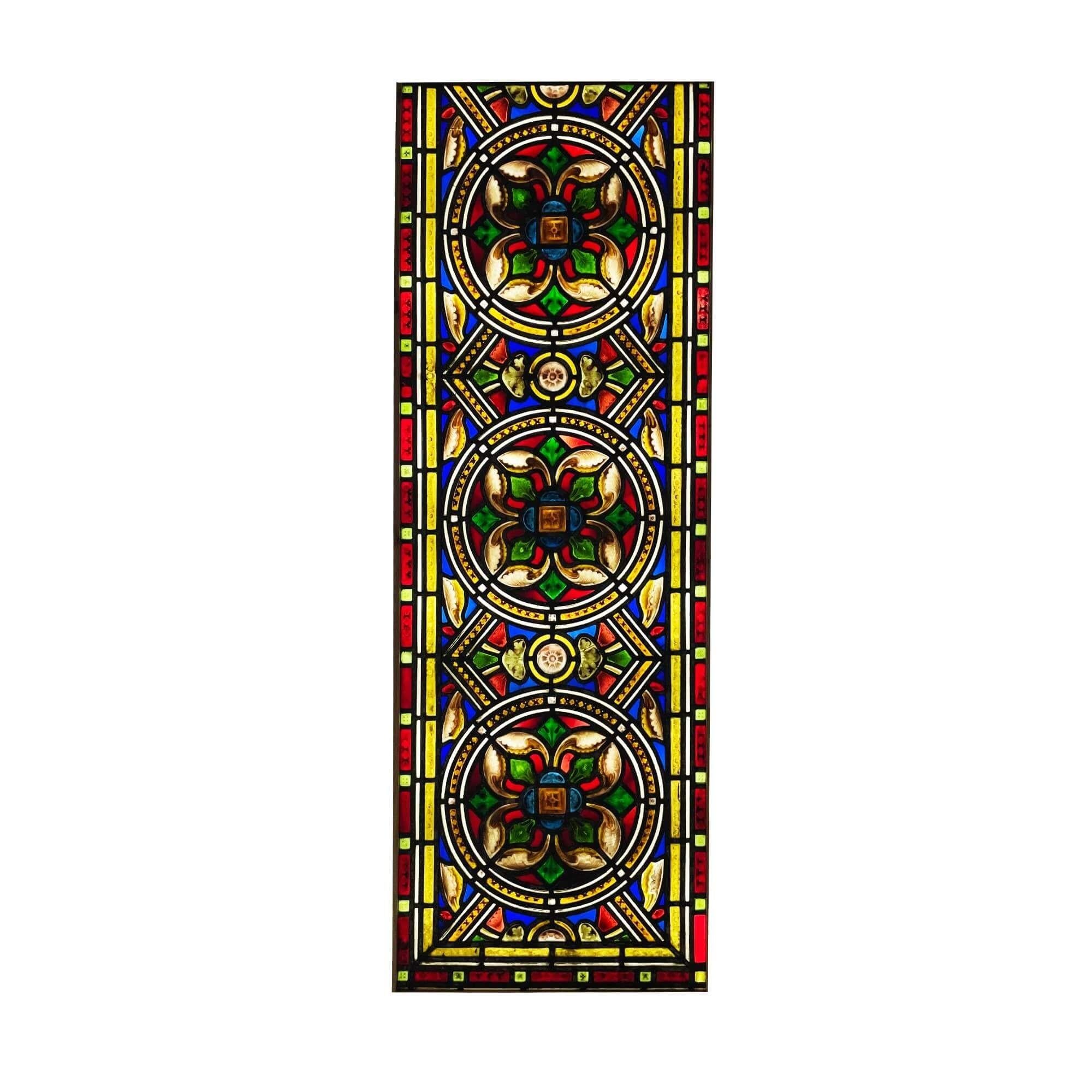 A large antique Medieval style late 19th century stained glass window, originally from a church in northern England. Three hand painted detailed flowers, thought to be a stylised Tudor Rose design, sit at the heart of this piece. It incorporates