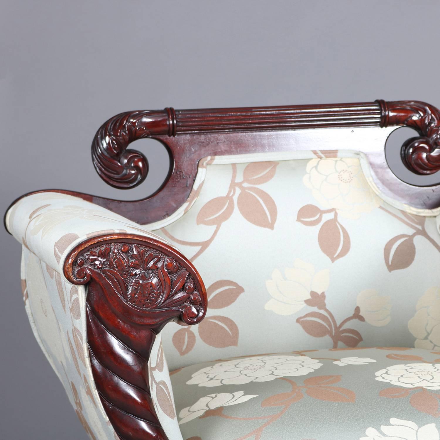 Antique pair of Meeks school American Empire mahogany chairs feature carved acanthus decorated scroll form crest, arms with carved cornucopia form scroll arms and raised on winged paw feet, floral upholstered, 19th century.

Measures: 35.75