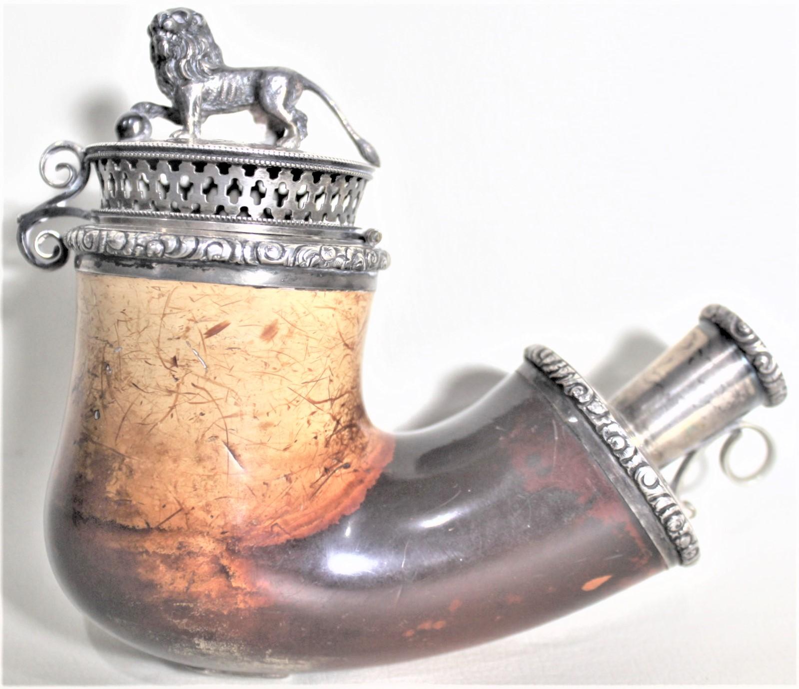 This antique meerschaum smoking pipe bowl is unsigned, but presumed to have been made in Germany or Austria in approximately 1900 in the period Biedermeier style. The body of the pipe is composed of meerschaum and has silver mounts featuring a