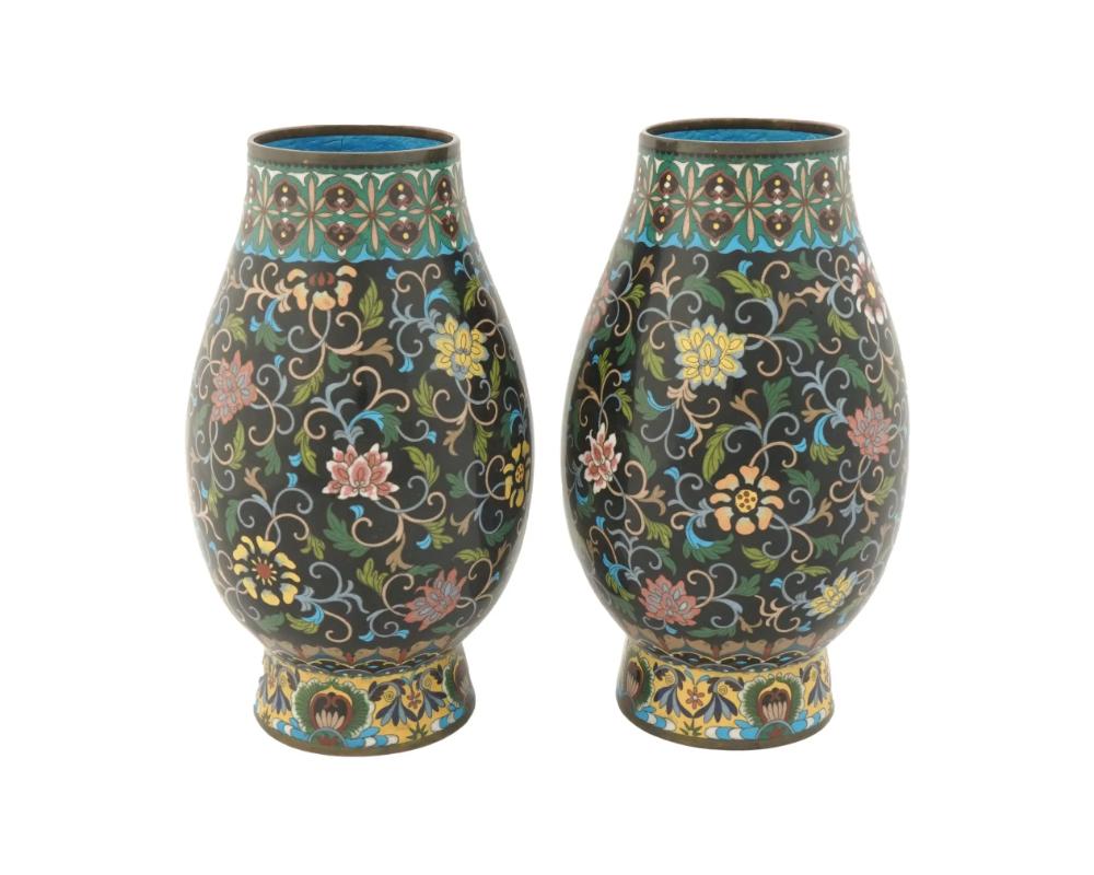 A pair of matching Japanese cast metal and cloisonne enamel vases richly decorated with polychrome floral ornaments on a black ground. Unmarked. Dated circa the late 19th century, Meiji period, 1868 to 1912. Antique and Vintage Asian Collectibles,