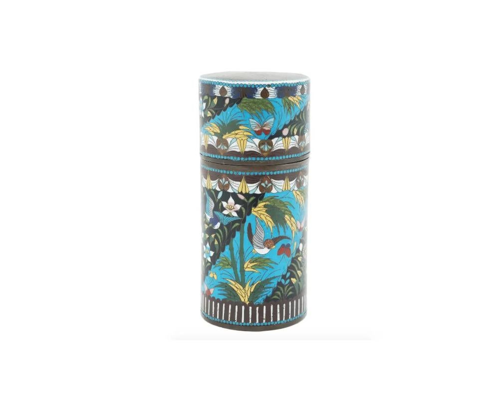 An antique Japanese lidded tea or spice caddy, of a cylindrical form, covered with a polychrome cloisonne enamel depicting intricate design with flowers, butterflies and birds. Unmarked. Meiji era, 1868 to 1912.
Dimensions: H 7 1/4 in. D 3 1/4 in.