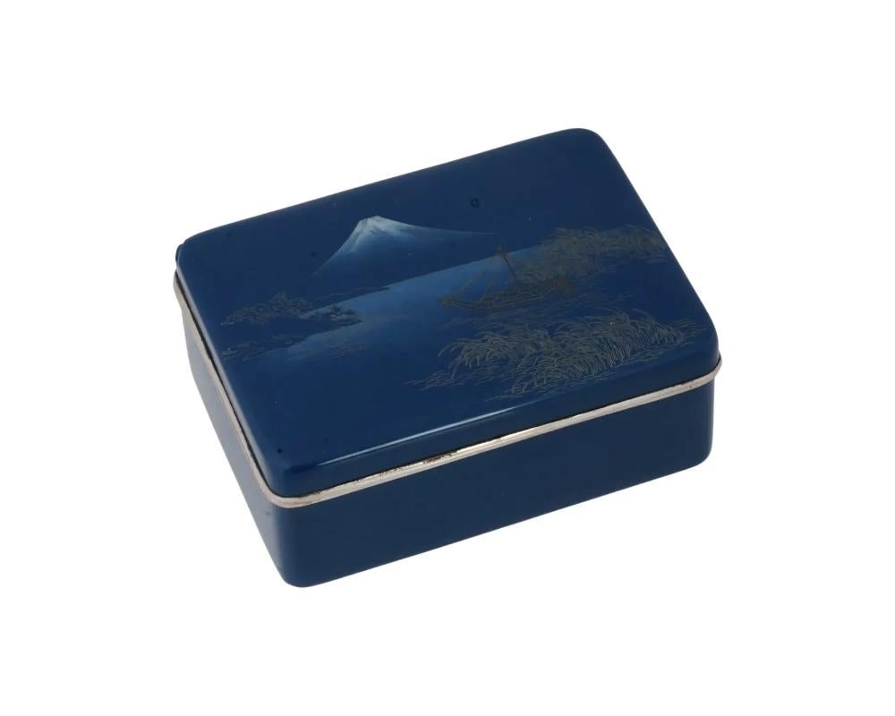 A rare antique Japanese closionne enamel silver mounts and gold wire cloisonne enamel design. Late Meiji period,
Rectangular shape. Cobalt blue ground color. The cover depicts a seascape with sailing ship and Mount Fuji in the distance. Silver