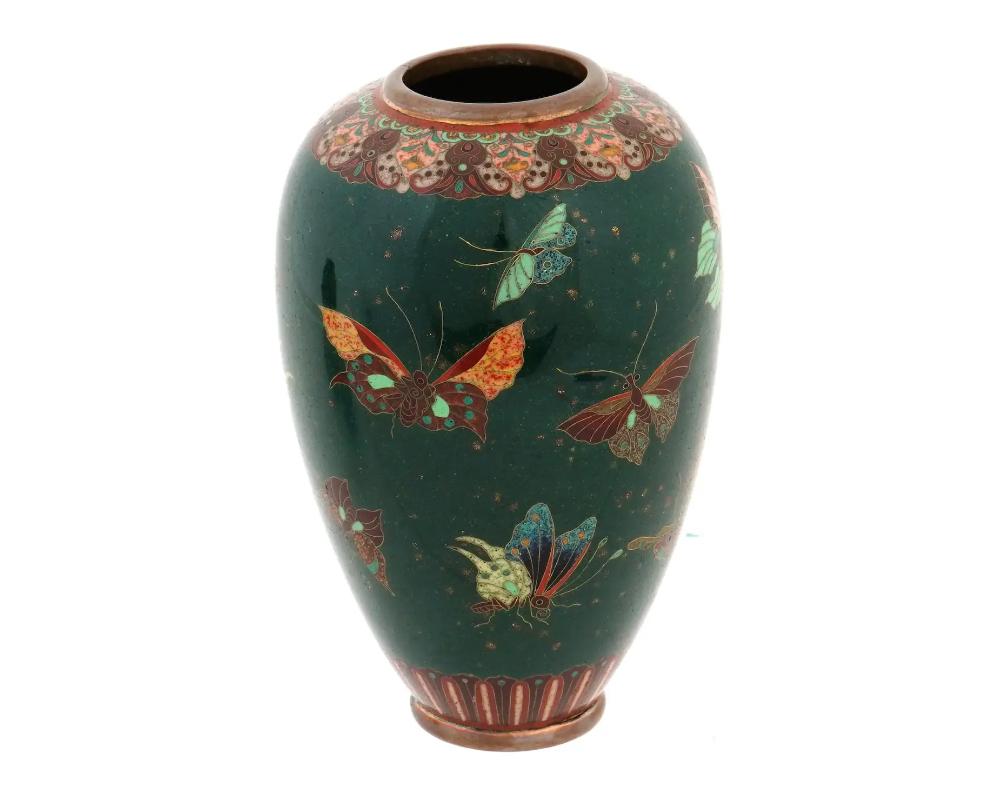 Attributed to Namikawa Yasuyuki, 1845 to 1927, a rare antique Japanese, late Meiji era, enamel vase. The vase has an urn shaped body and a wide fluted neck. The body of the vase is adorned with polychrome images of butterflies made in the Cloisonne