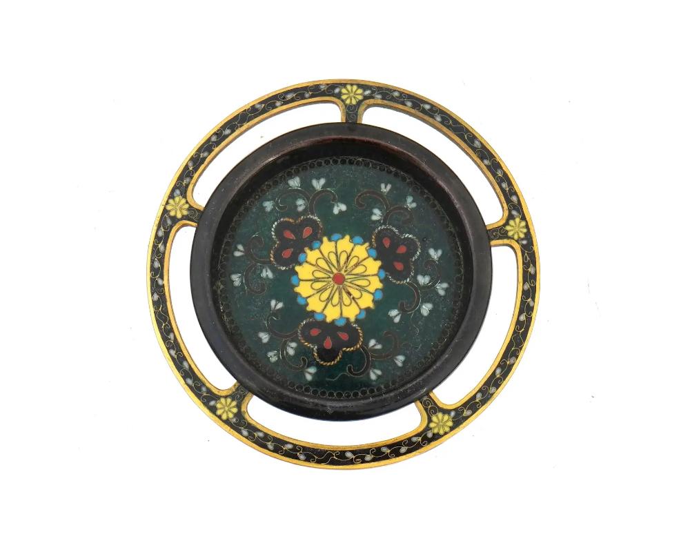 An antique Japanese gilt copper Fusuma Hikite sliding door handle with polychrome cloisonne enamel design. Late Meiji period, before 1912. The door pull has a grip recess. Floral ornaments against the dark green background. Collectible Oriental
