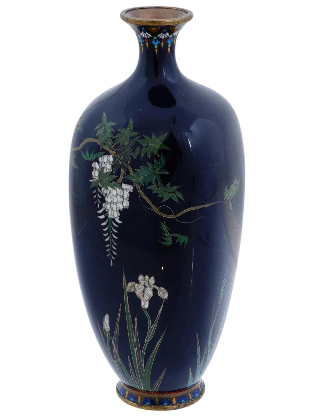 An antique Japanese Hayashi school brass and enamel vase, Meiji period, 1868 to 1912. The baluster body is finely worked in silver wire and adorned with a polychrome design representing wisteria flowers and irises made in the cloisonne technique on