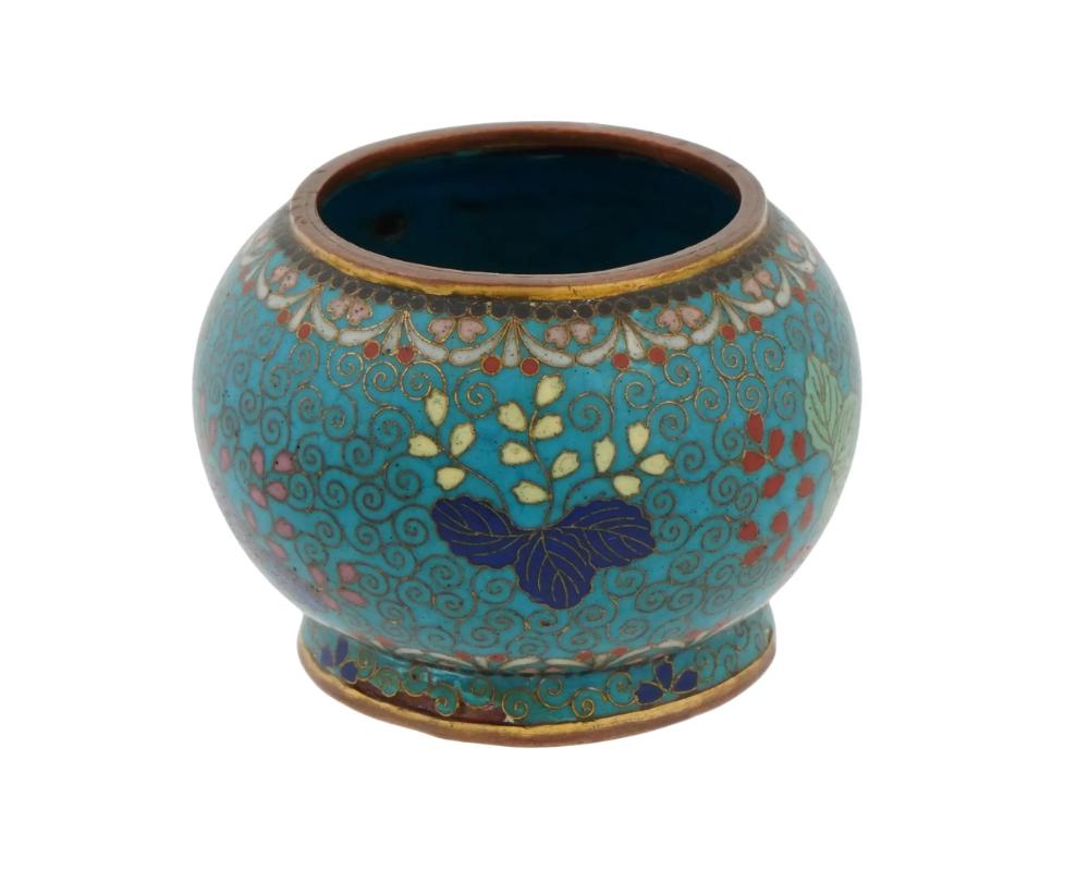 An antique Japanese early Meiji period cloisonne vase, attributed to the master artisan Namikawa Yasuyuki. The intricately detailed floral and foliate patterns, meticulously rendered in vibrant enamel hues, exemplify the mastery of cloisonne
