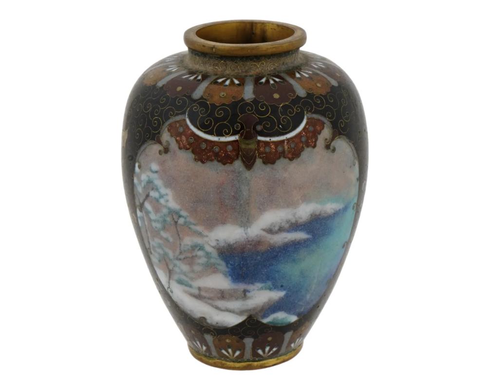 An antique Japanese vase from the early Meiji period, decorated with enamel using the cloisonne technique. The wide vase with a narrow neck and a complex, varied pattern. At the base and around the neck it has a rhythmic decoration of alternating