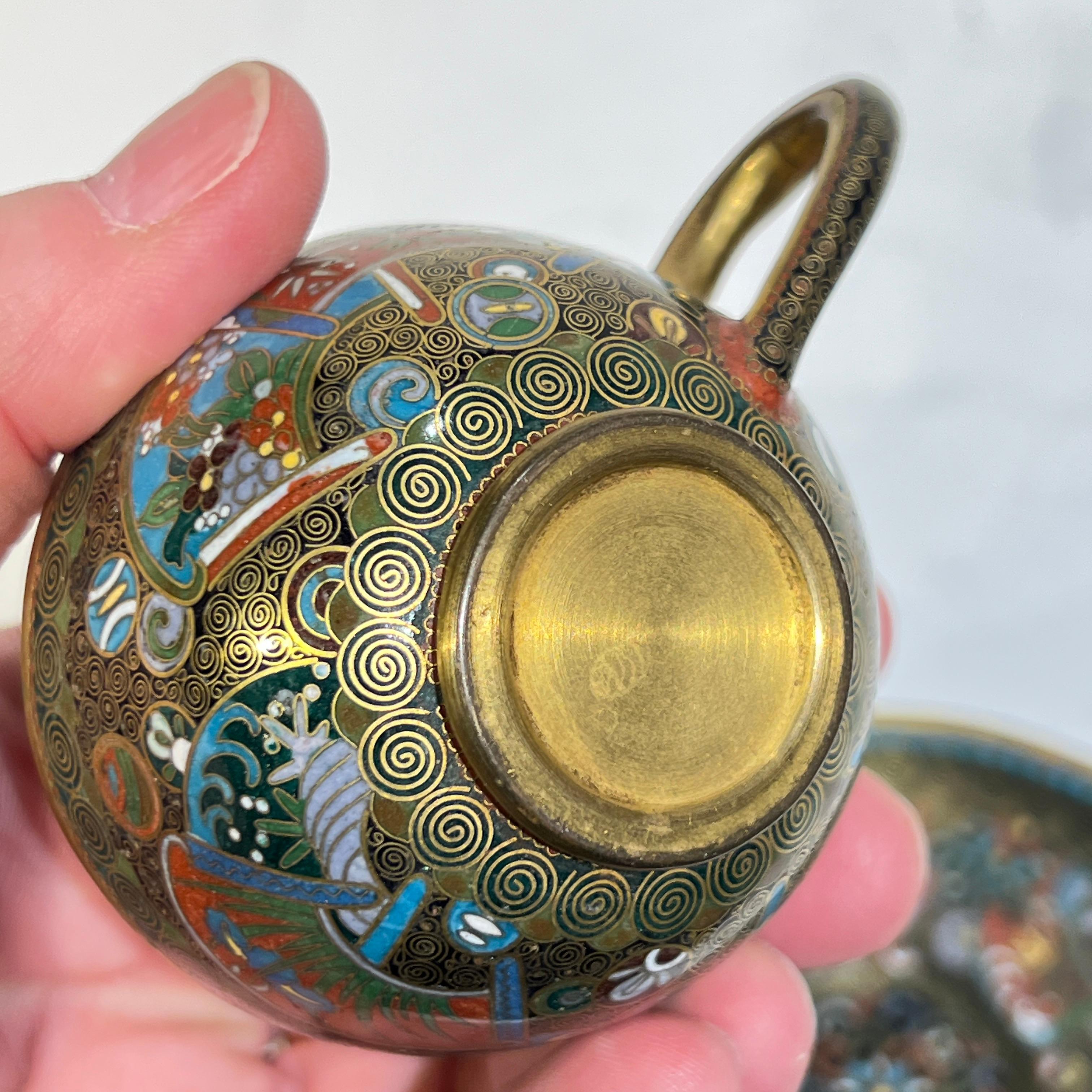 Antique Meiji period Japanese set set with exceptional cloisonne inlaid enamels, including pot, creamer, sugar and two cups and saucers.  Unsigned and in excellent condition.  Tea pot 4 inches tall.