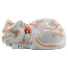 Antique Meiji Kutani model of a recumbent sleeping cat, 19th Century