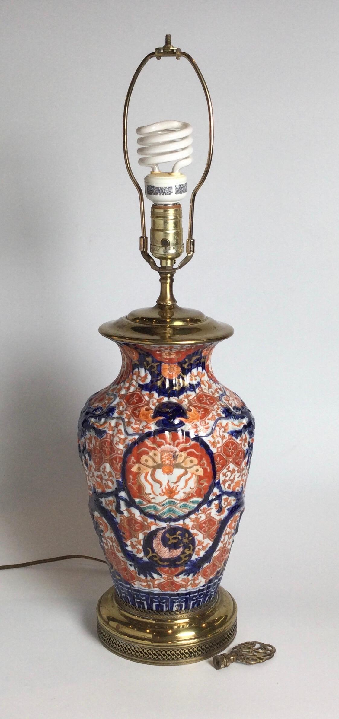 Classic iron red and cobalt blue Imari Porcelain vase now as a lamp/ The circa 1900 Japanese vase, handprinted in the traditional colors, electrified probably in the 1920's. The shade is for photographic purposes only and not included. 22 inches to