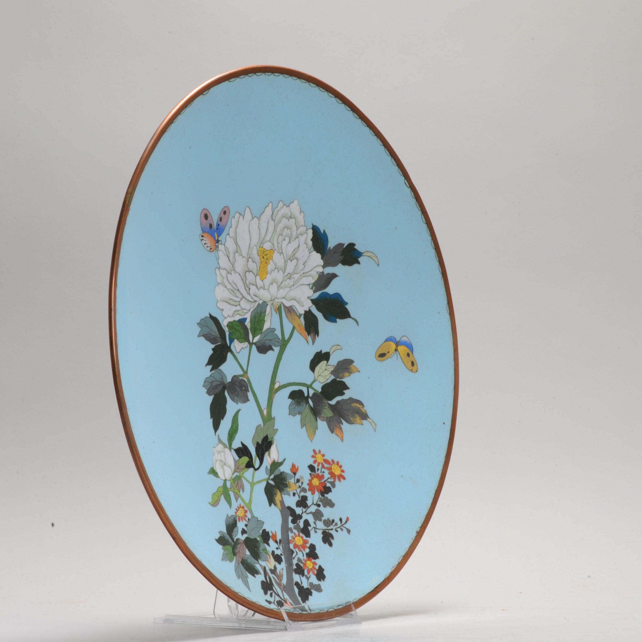 Lovely and beautifully made piece with different kinds of flowers and butterflies on a blue base.

This piece is made by a talented artist, Ito Yusaburo.
The bottom mark.

Cloisonné is an enamelling technique in which the pattern is formed by wires