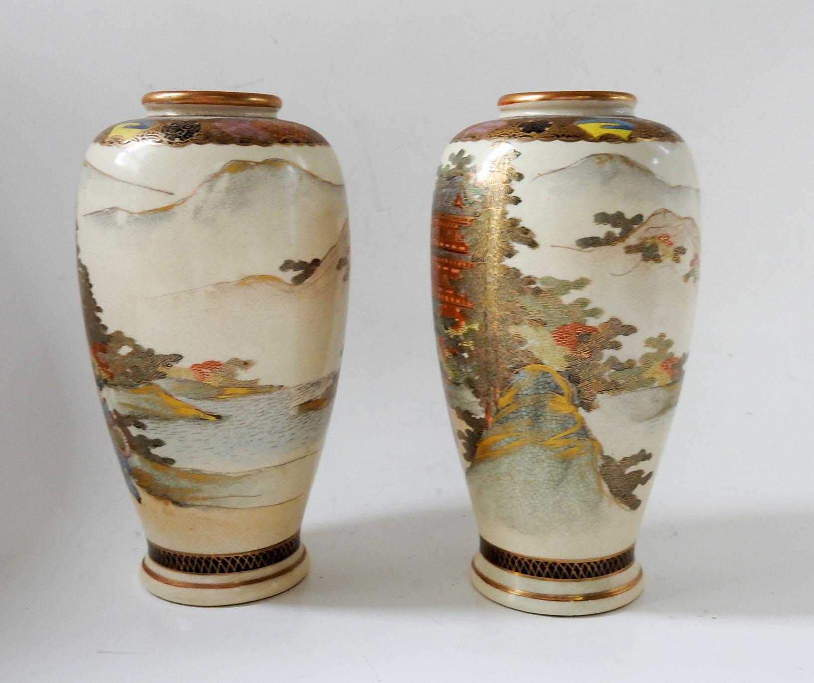 Circa 1900 pair of Satsuma vases.  Hand painted coastal landscape, mountains, women and children outside of elaborate homes. Signed on the bottom with the Shimazu Clan crest, wear to bottom.