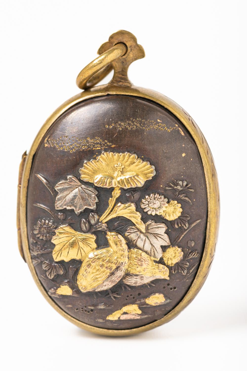 Rare 19th century Shakudo Meiji Double-Sided mixed media locket, made in silver and yellow gold probably 18ct. One side of the locket depicts a pair of quails amongst foliage, chrysanthemums, and gentian. The quail 'uzura' represents the fighting