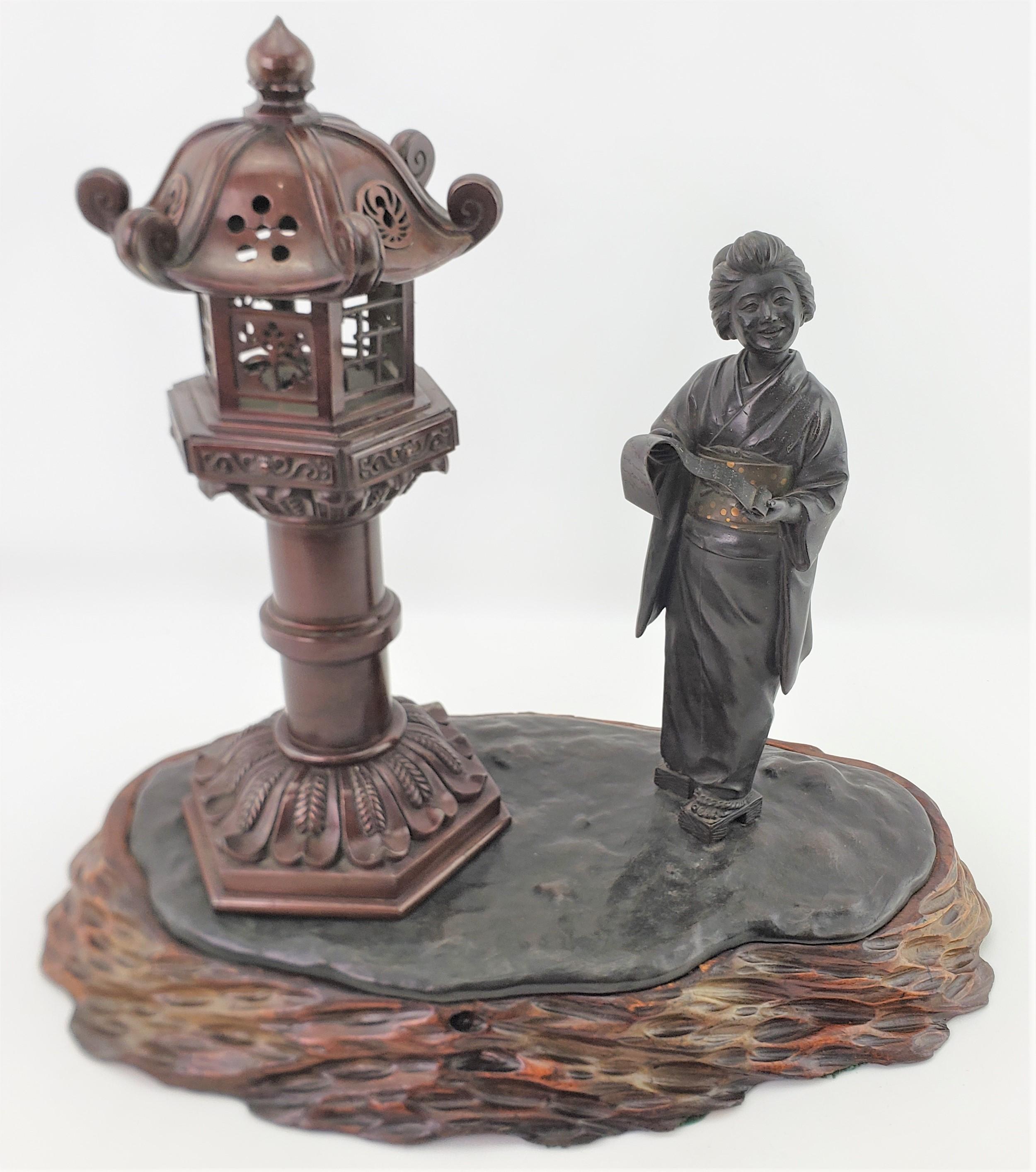 This large antique Meiji period Japanese patinated and polychromed bronze is signed by an unknown artist and presumed to have been made in approximately 1880 in the period Meiji style. The bronze is extremely detailed in the casting and depicts a