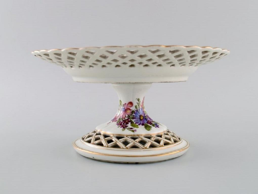 Antique Meissen compote in openwork porcelain with hand-painted flowers, insects and gold decoration. 
Marcolini period 1774-1814.
Museum quality.
Measures: 23.5 x 12.5 cm.
In excellent condition.
Stamped.
1st factory quality.