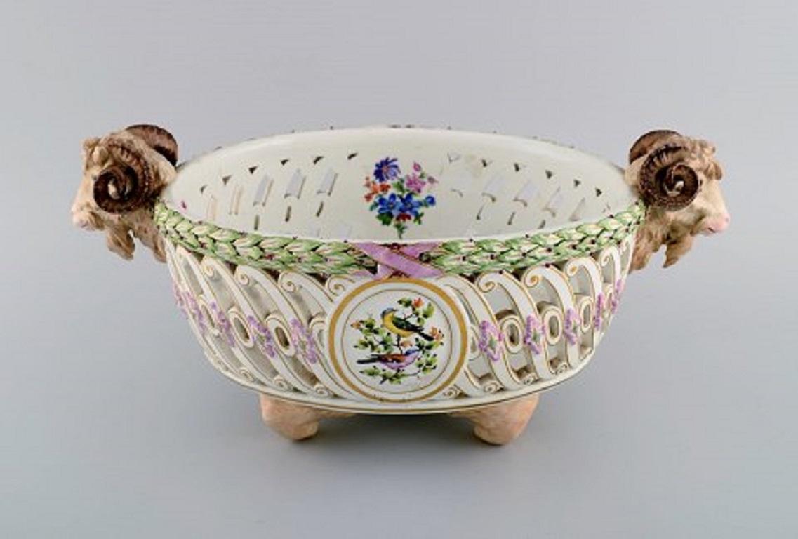 Antique Meissen compote on feet with modelled ram heads in openwork porcelain. 
Hand-painted bird motifs, foliage and gold decoration. 
Museum quality. 
Dated 1817-1824.
Measures: 37 x 24 x 16 cm.
In excellent condition.
Stamped.
1st factory