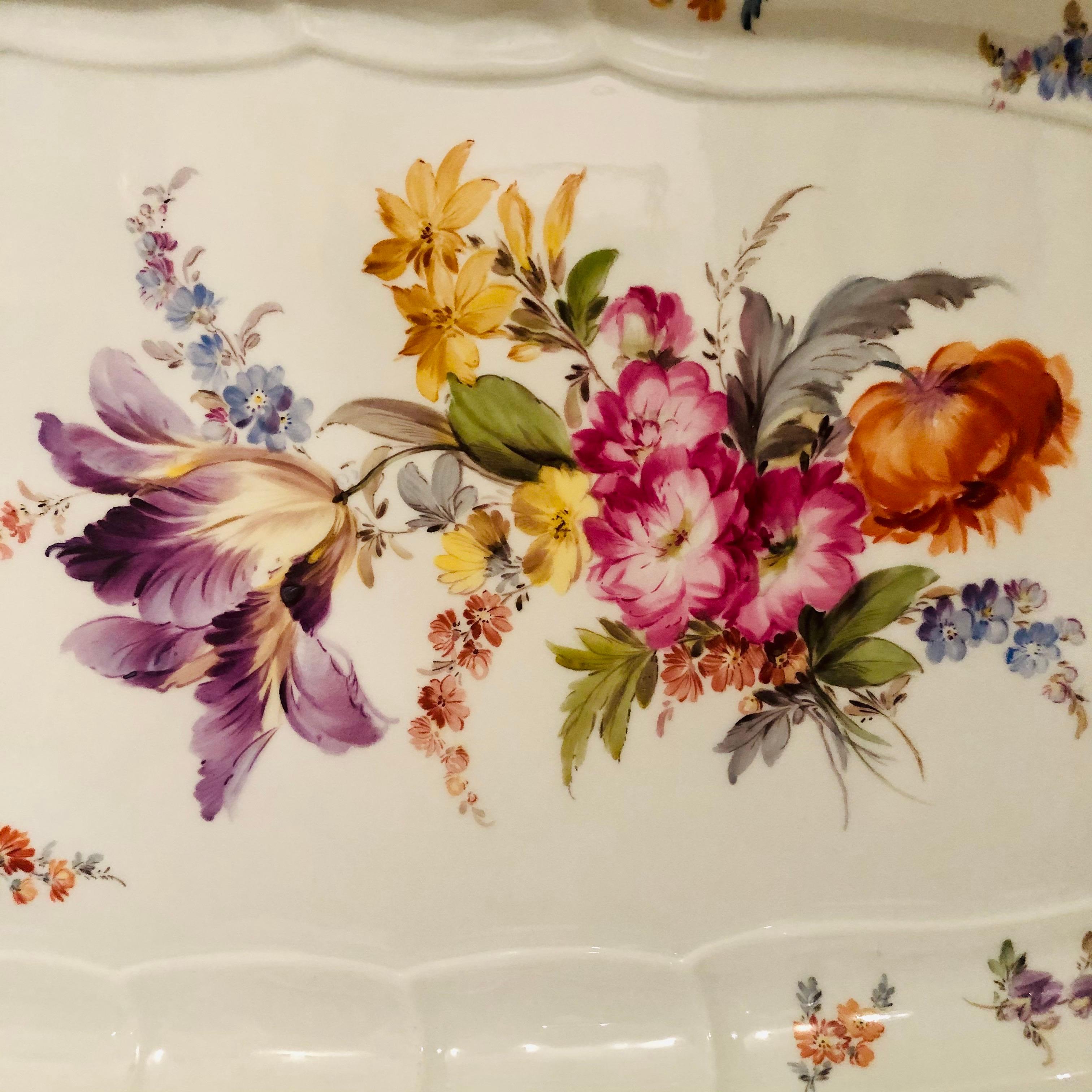 I want to offer you this beautifully painted antique Meissen fish platter that is in the New Brandenstein pattern. The Meissen platter is painted with a large bouquet of flowers including a gorgeous purple Rembrandt tulip surrounded by other flowers