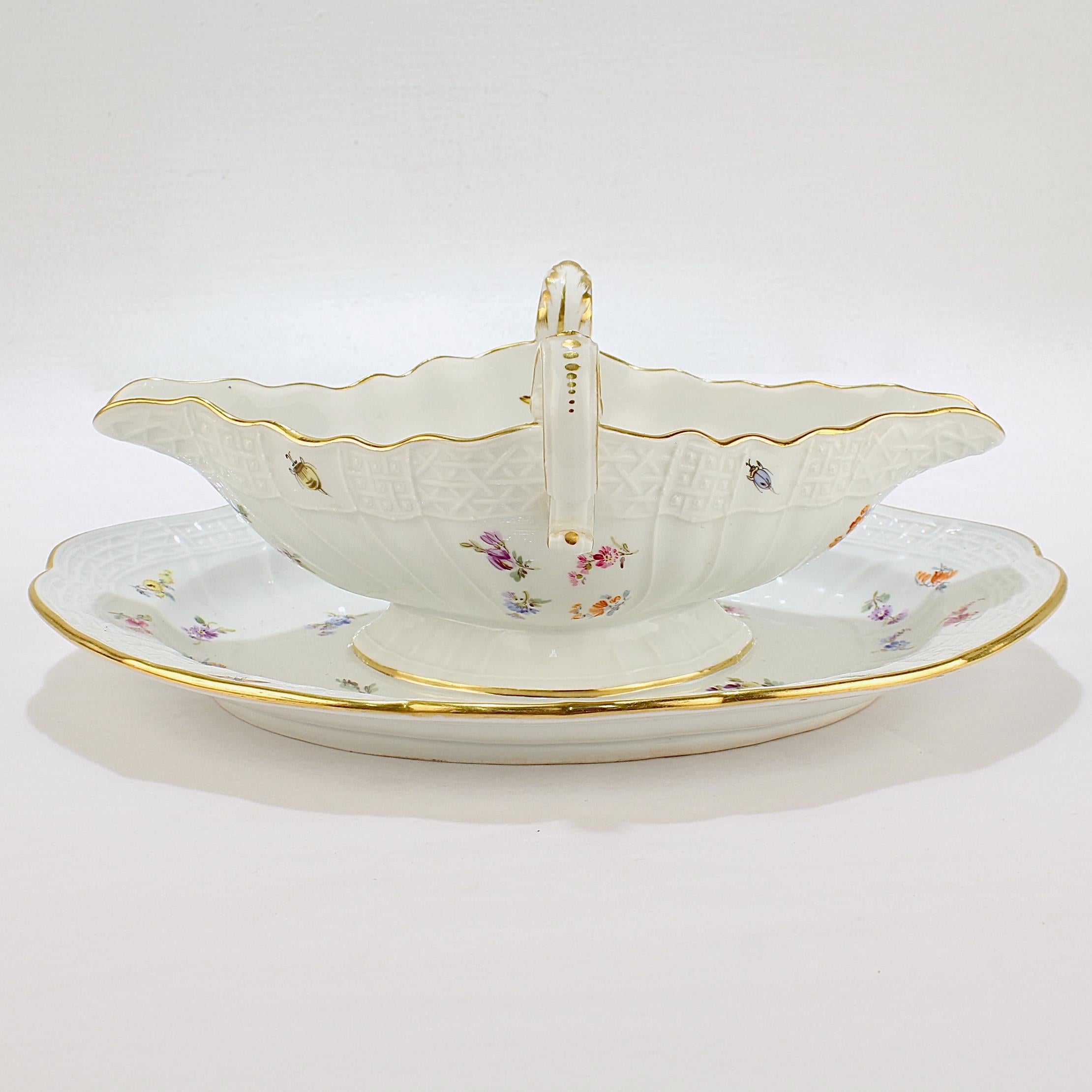 A fine Meissen gravy or sauce boat.

By the Meissen Porcelain Manufactory. 

Having tin handles, two spouts, and an integral undertray.

In the Neu Brandenstein relief pattern.

With its trelliswork border and floral spray and insect