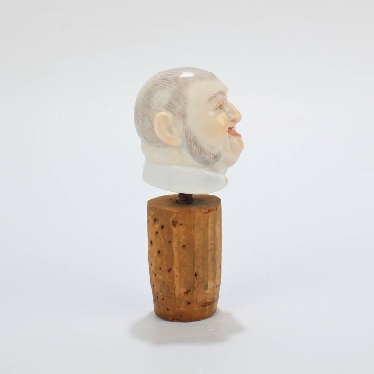 A fine and rare Meissen Porcelain figural bottle stopper or cork decoration.

The figural stopper depicts the bust of a jovial man mounted with an threaded iron stem meant to screw into a bottle's cork.

These forms were quite popular in the