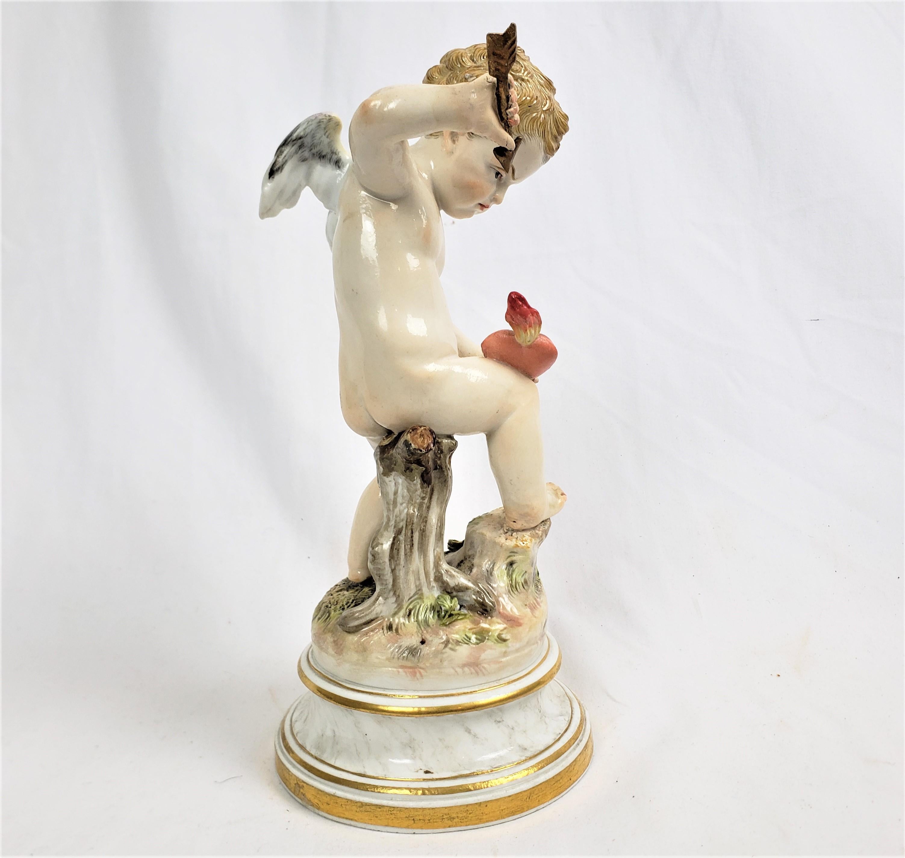 German Antique Meissen Porcelain Figurine of Cupid Holding an Arrow & Flaming Heart For Sale