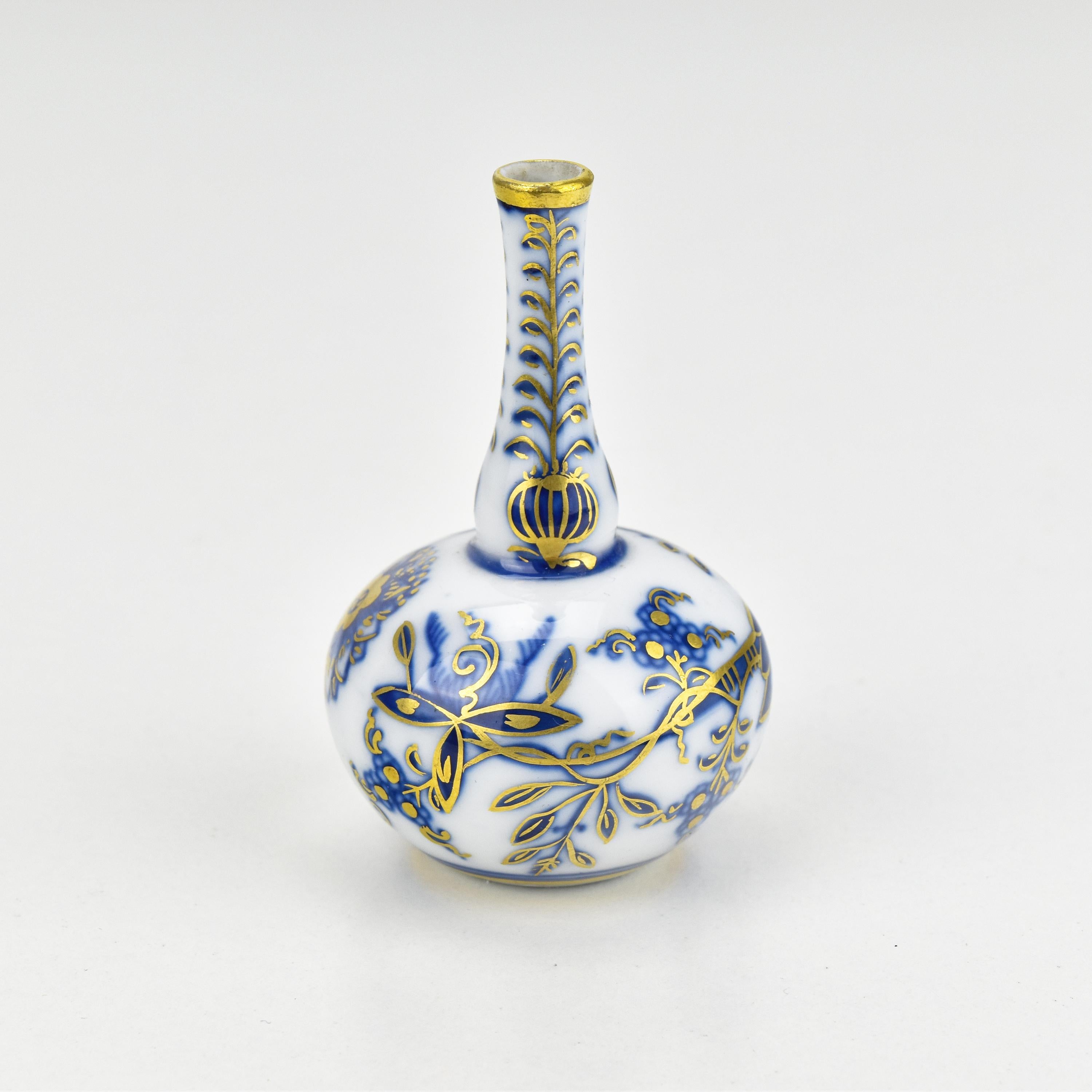 This antique miniature vase from Meissen is a remarkable example of fine porcelain craftsmanship. 

Crafted from pristine white porcelain, it features the iconic cobalt blue 