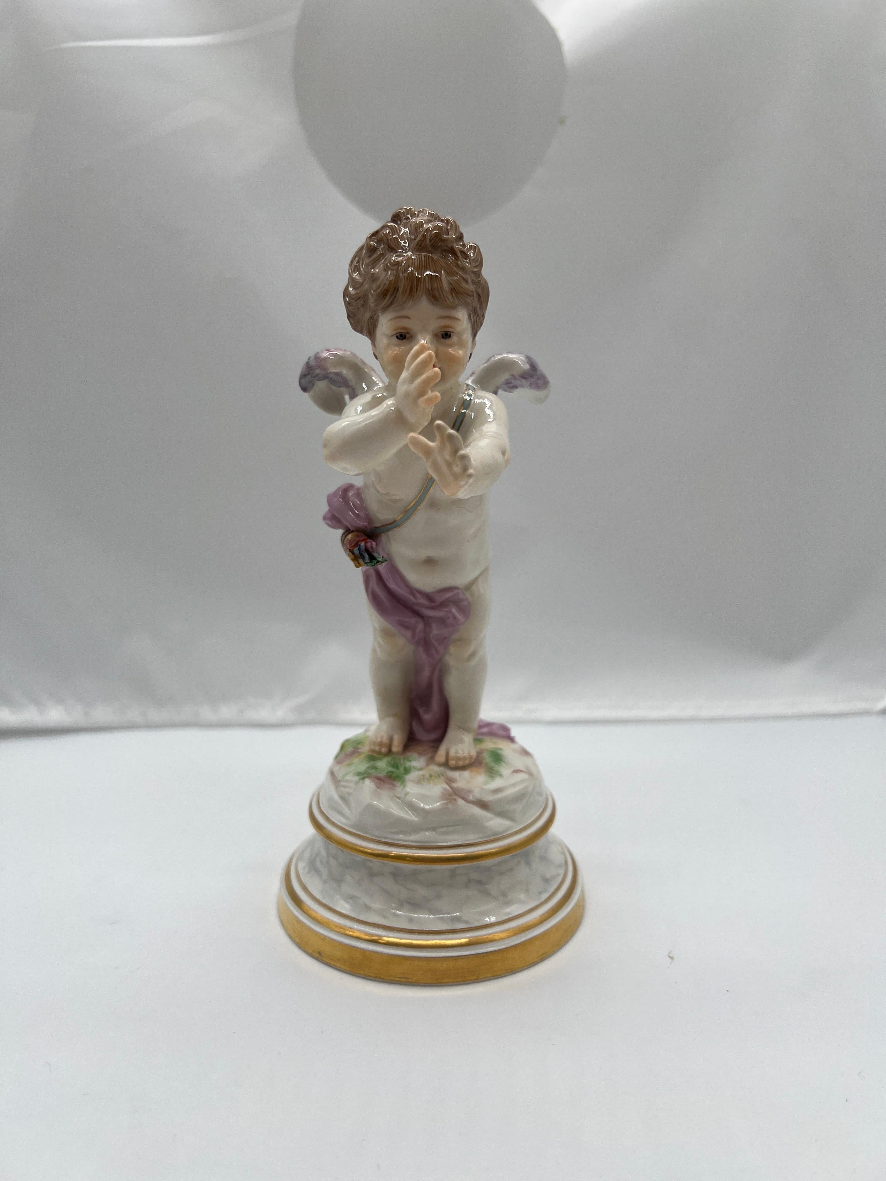 Meissen, 19th century.

A fine quality Meissen porcelain figure featuring a cupid figure draped in a purple cloth with petite wings and very realistic features. This piece was designed by the famous Meissen artist Heinrich Schwabe and is one of the