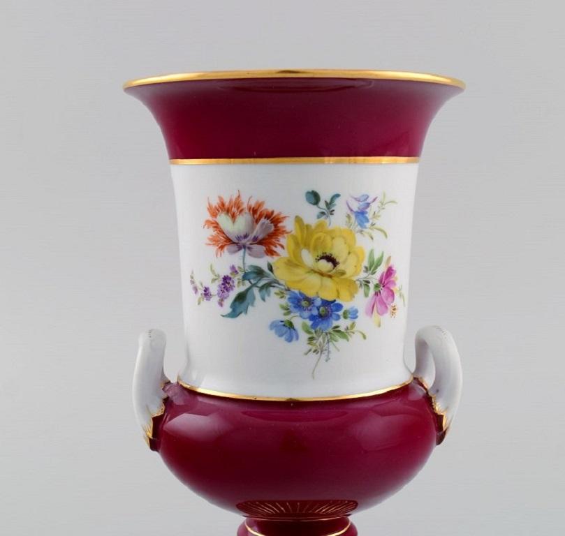 Antique Meissen porcelain vase with hand-painted flowers. 
Purple and gold decoration. Ca. 1900.
Measures: 19.5 x 11 cm.
In excellent condition.
Stamped.