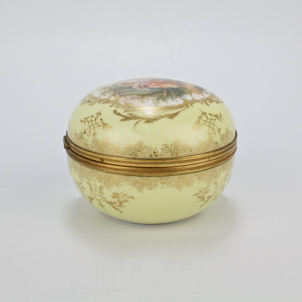 A fine, yellow ground Meissen porcelain box mounted with a gilt bronze frame.

The yellow ground is a relatively rare color for Meissen. The central cartouche on the lid depicts a young beauty in a garden scene together with a child and dog. The