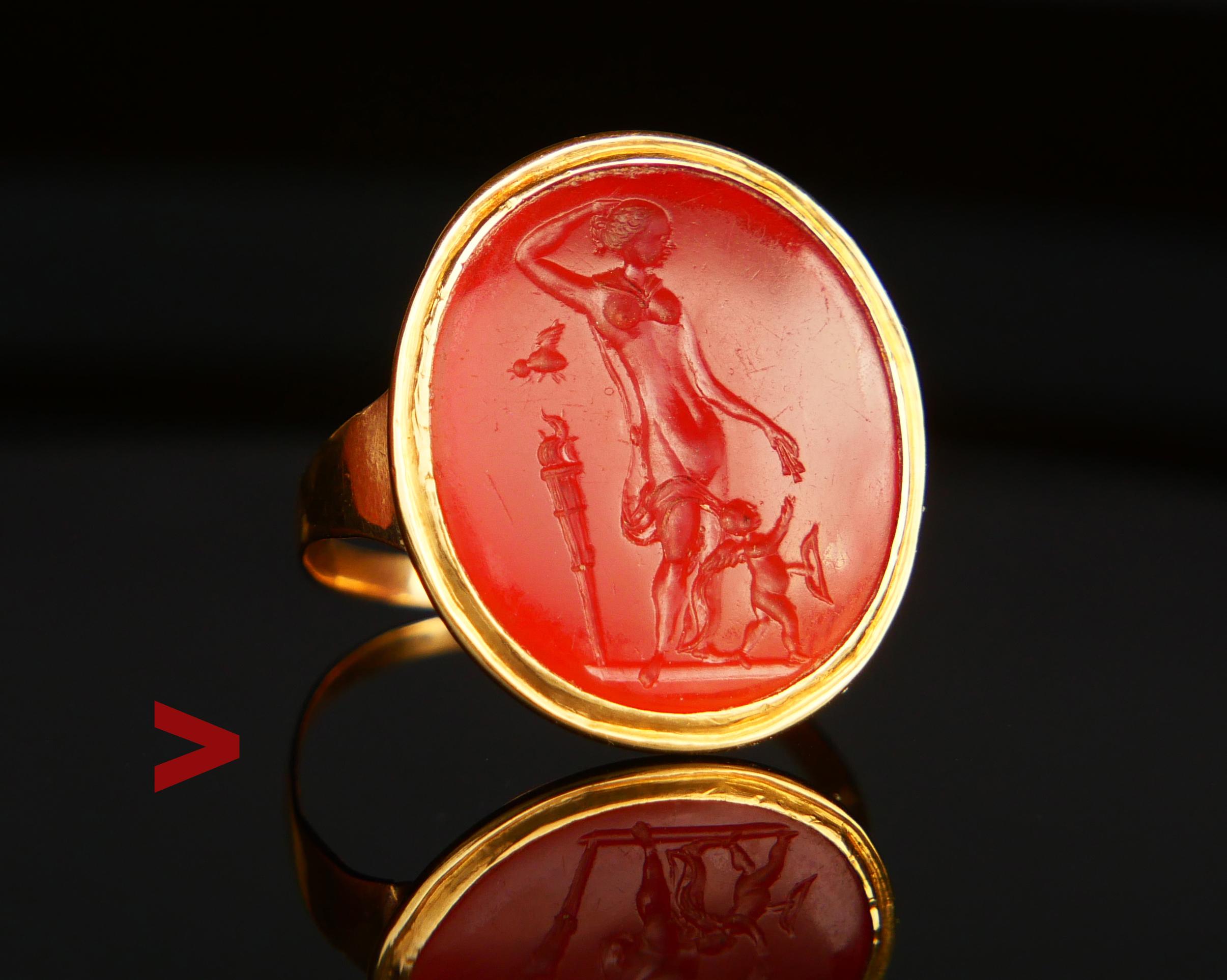 Old Signet Unisex intaglio 18K (tested) Gold Ring featuring Carnelian(type of Agate)stone with the detailed carved depiction of Cupid receiving the arrows from his mother, goddess Venus Victrix or Aphrodite standing pregnant close to a torch with a