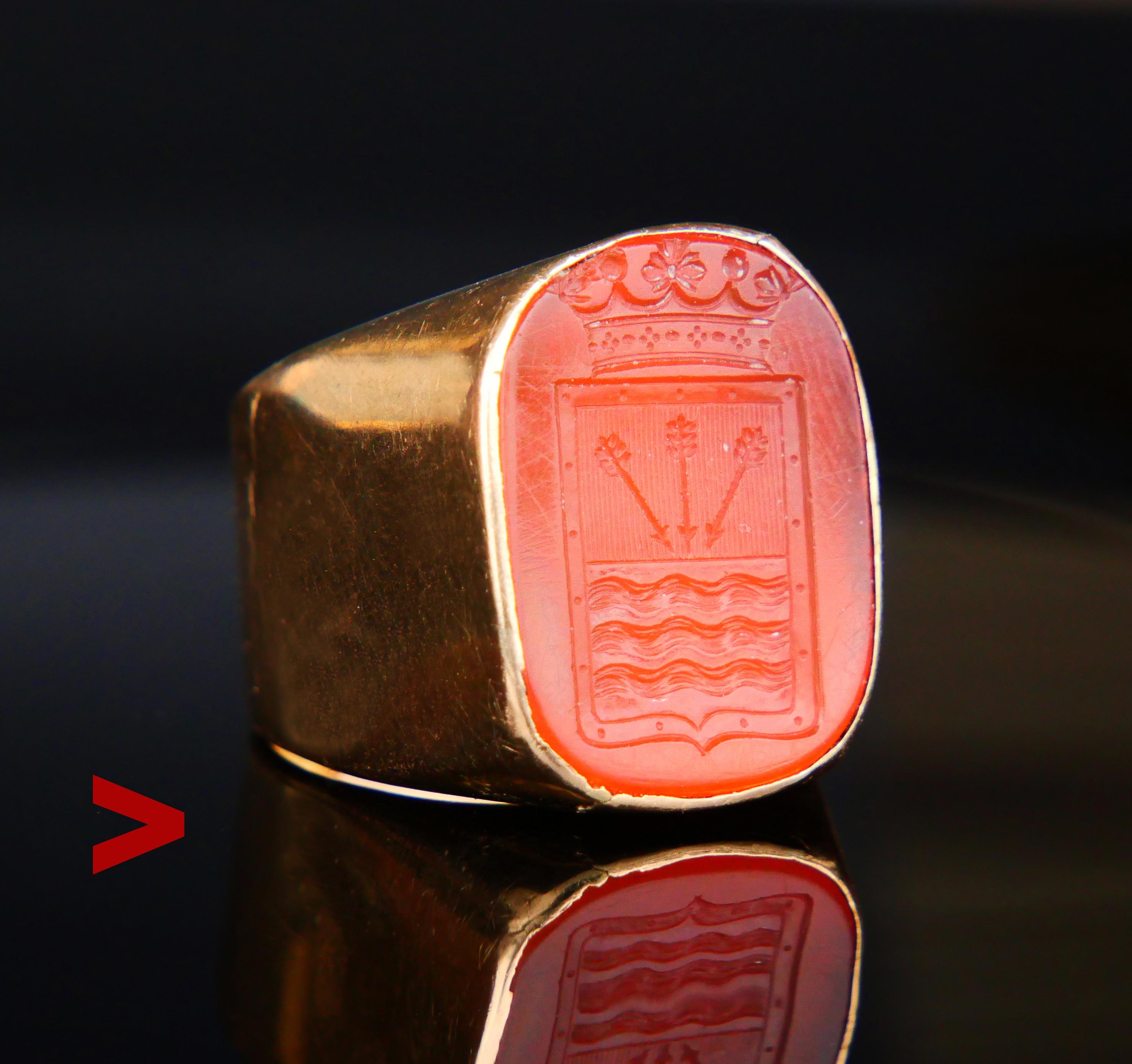 Signet Intaglio Ring featuring Carnelian (type of Agate) stone with the detailed heraldic depiction of Von Boltenstern's coat of arms under the crown of Nobility set into wide band ring in solid 18K Orange Gold.. The body of the stone is dark Orange
