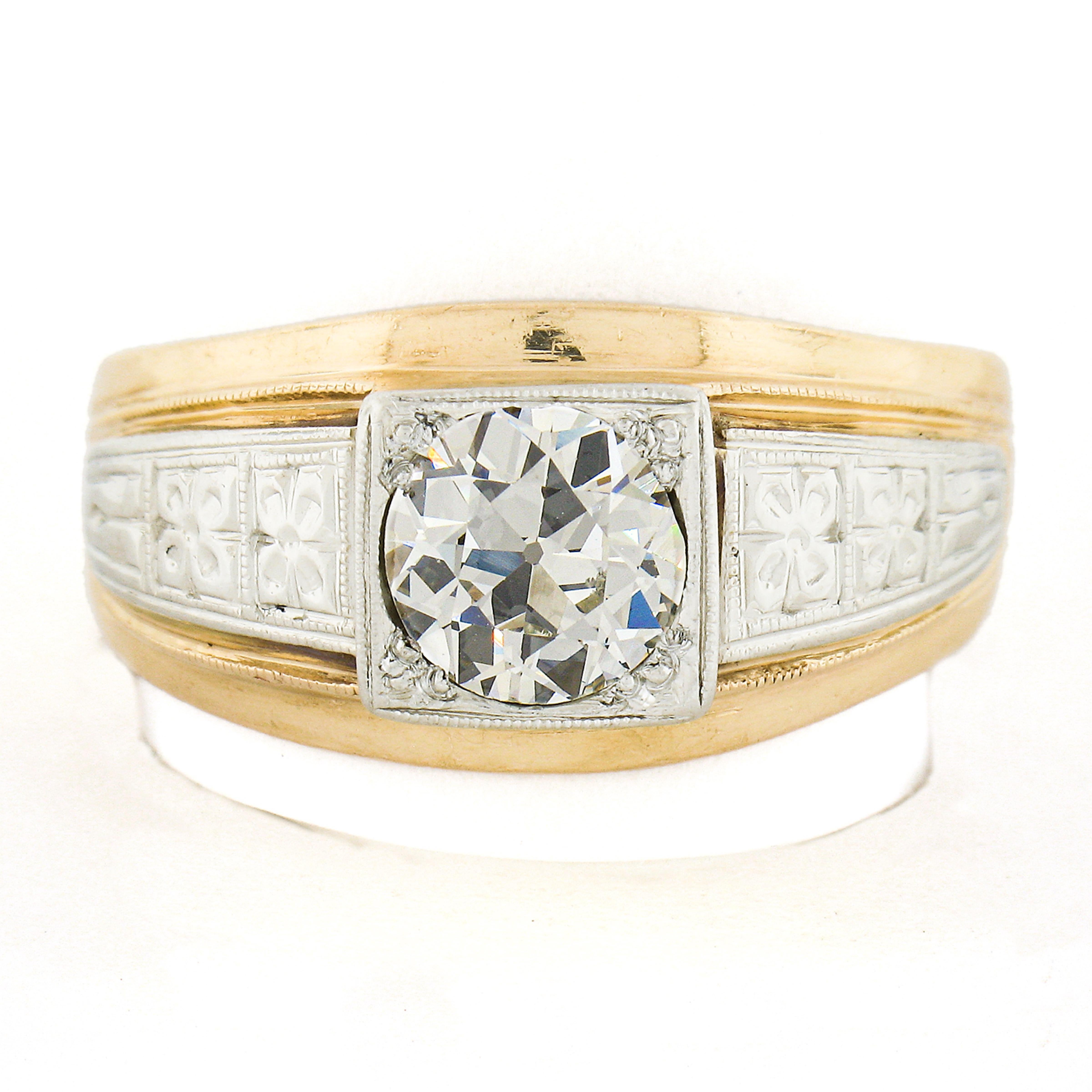 This antique men's ring was crafted during the 1930's in solid 14k yellow gold with white gold shoulders that are adorned with wonderful floral patterns. The ring is set with a solitaire old European cut diamond that is neatly pave set at the center