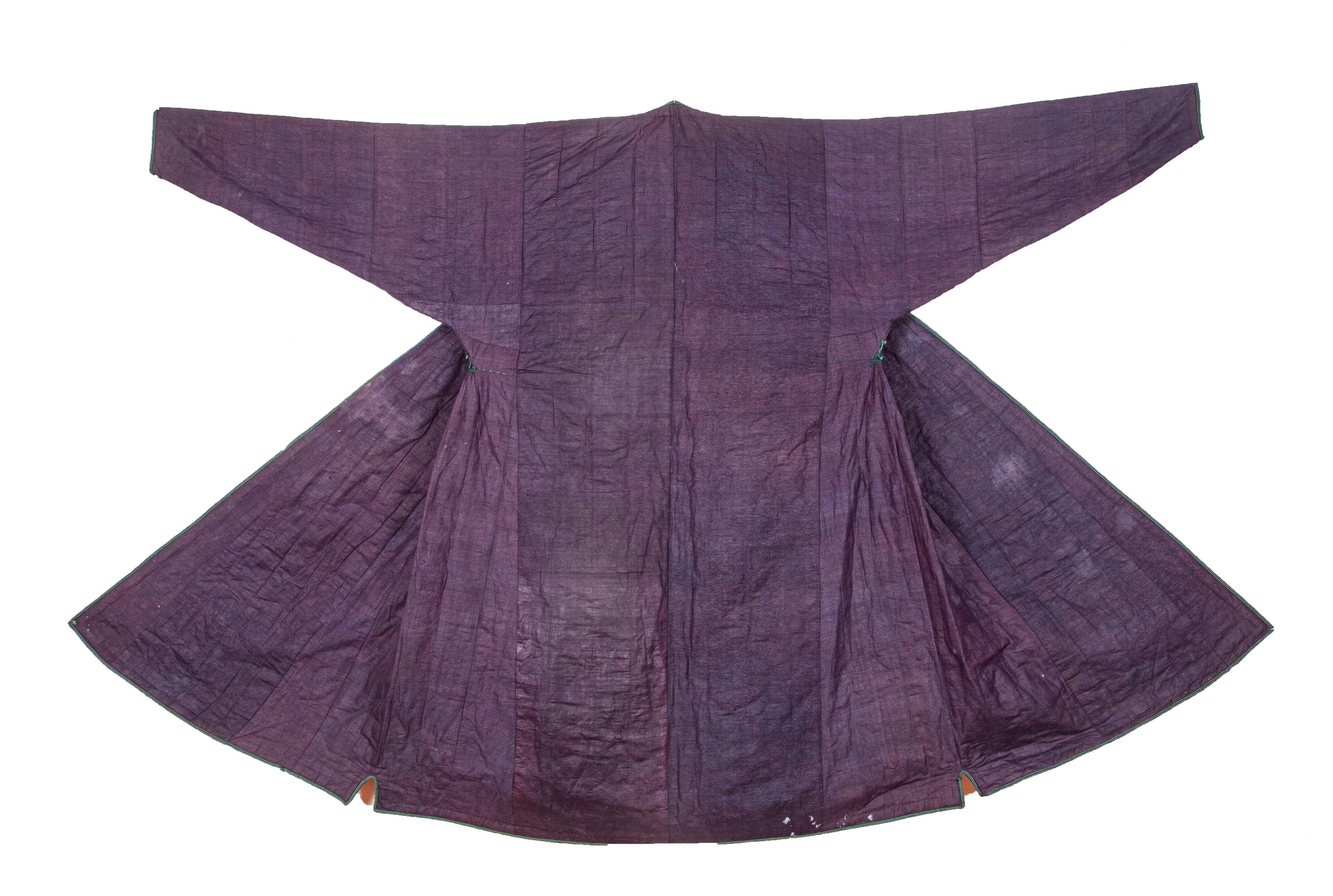 The surface of this chapan is plain handwoven purple silk and the lining is handwoven cotton in indigo block printed by hand.
The condition is superb for the age, both a collector's and users item.