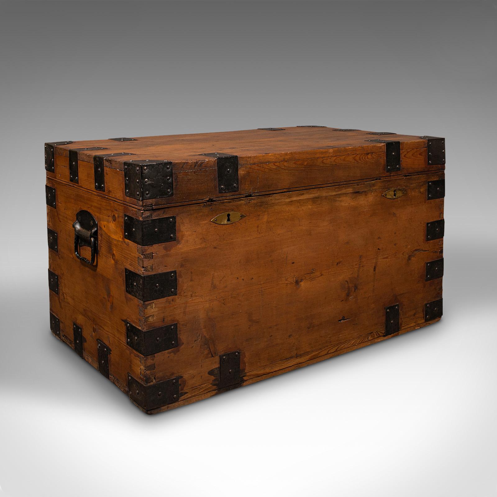 This is a substantial antique mercantile chest. An English, pine shipping trunk with tin lined interior, dating to the late Victorian period, circa 1880.

Bound and braced, with an attractive Victorian appeal
Displays a desirable aged patina and