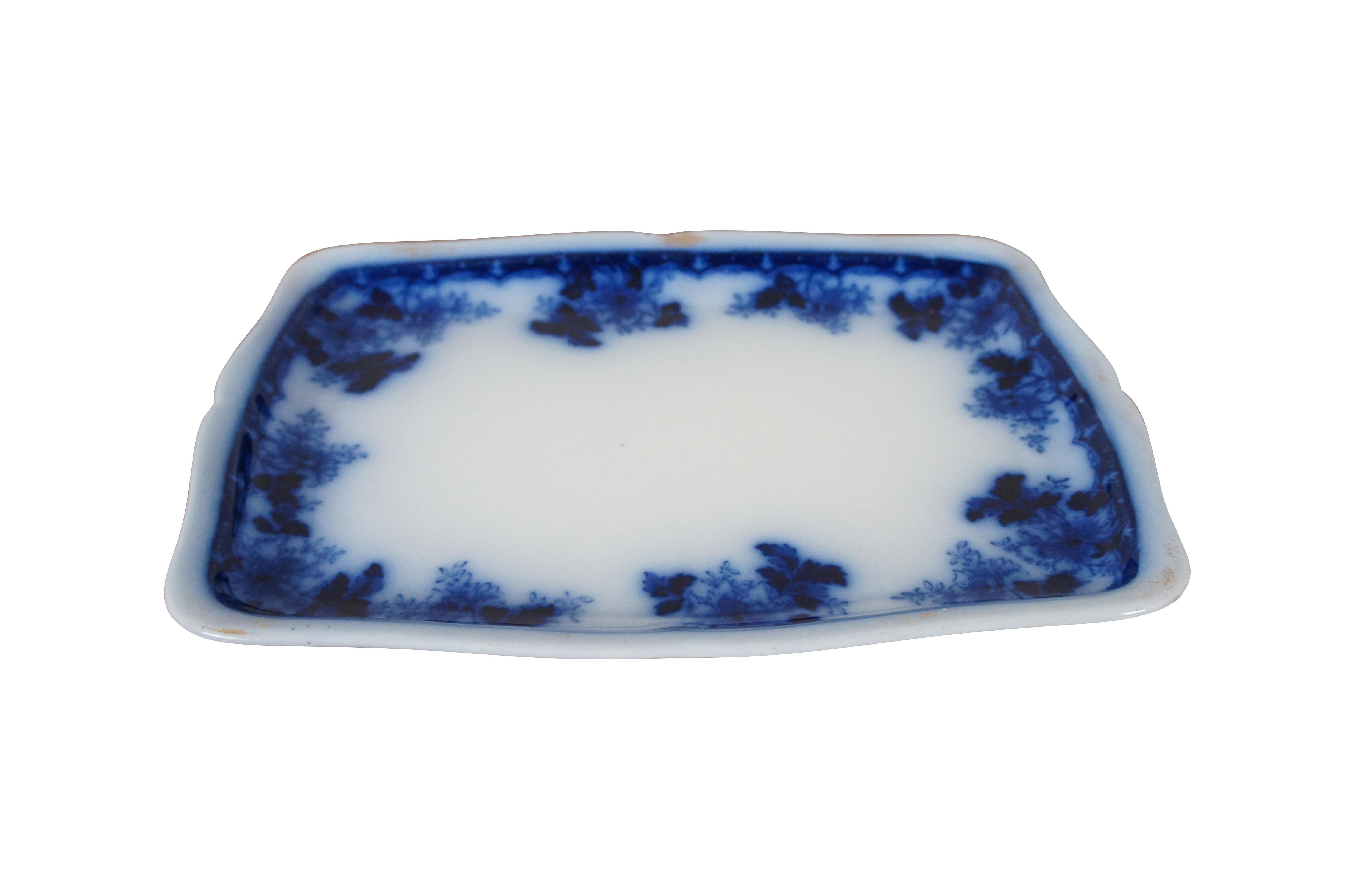 Antique flow blue semi-porcelain / semi viterous serving platter or tray by Mercer Pottery Company in the Luzerne pattern. Rectangular in form with slightly scalloped edges and a border design of leaves and flowers. Edges were originally