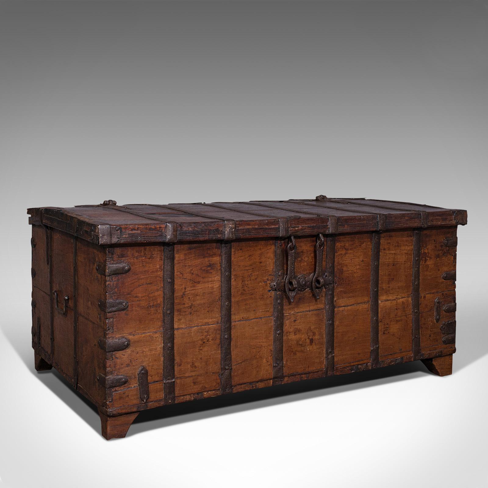 This is an antique merchant's chest. An Oriental, solid teak and iron bound trunk, dating to the William III period, circa 1700.

Beguiling, aged chest of superior and heavy proportion
Displays a desirable aged patina throughout
Solid teak