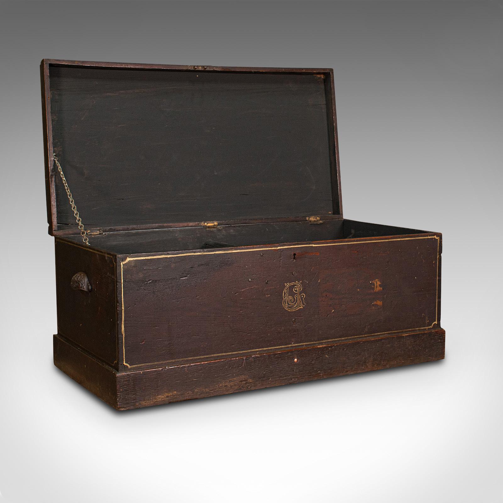 This is an antique merchant's tool chest. An English, stained pine craftsman's trunk, dating to the late Victorian period, circa 1900.

Pleasingly robust with charming personalised detail
Displays a desirable aged patina and signs of industrial