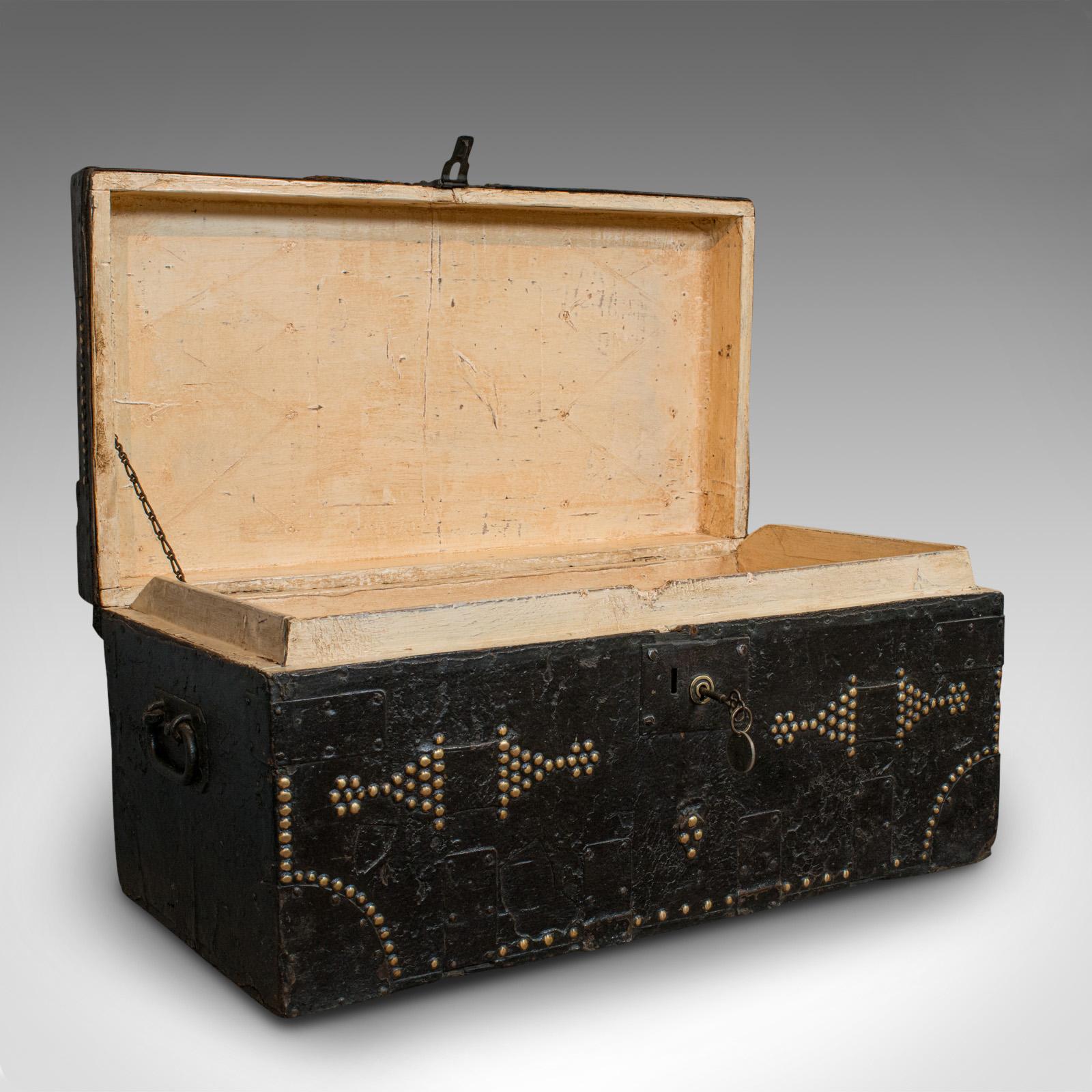 This is an antique merchant's trunk. An English, metal bound, ebonised pine tool chest, dating to the Victorian period, circa 1890.

Displays a desirable aged patina and weathering
Metal bound and riveted for strength over quality, ebonised