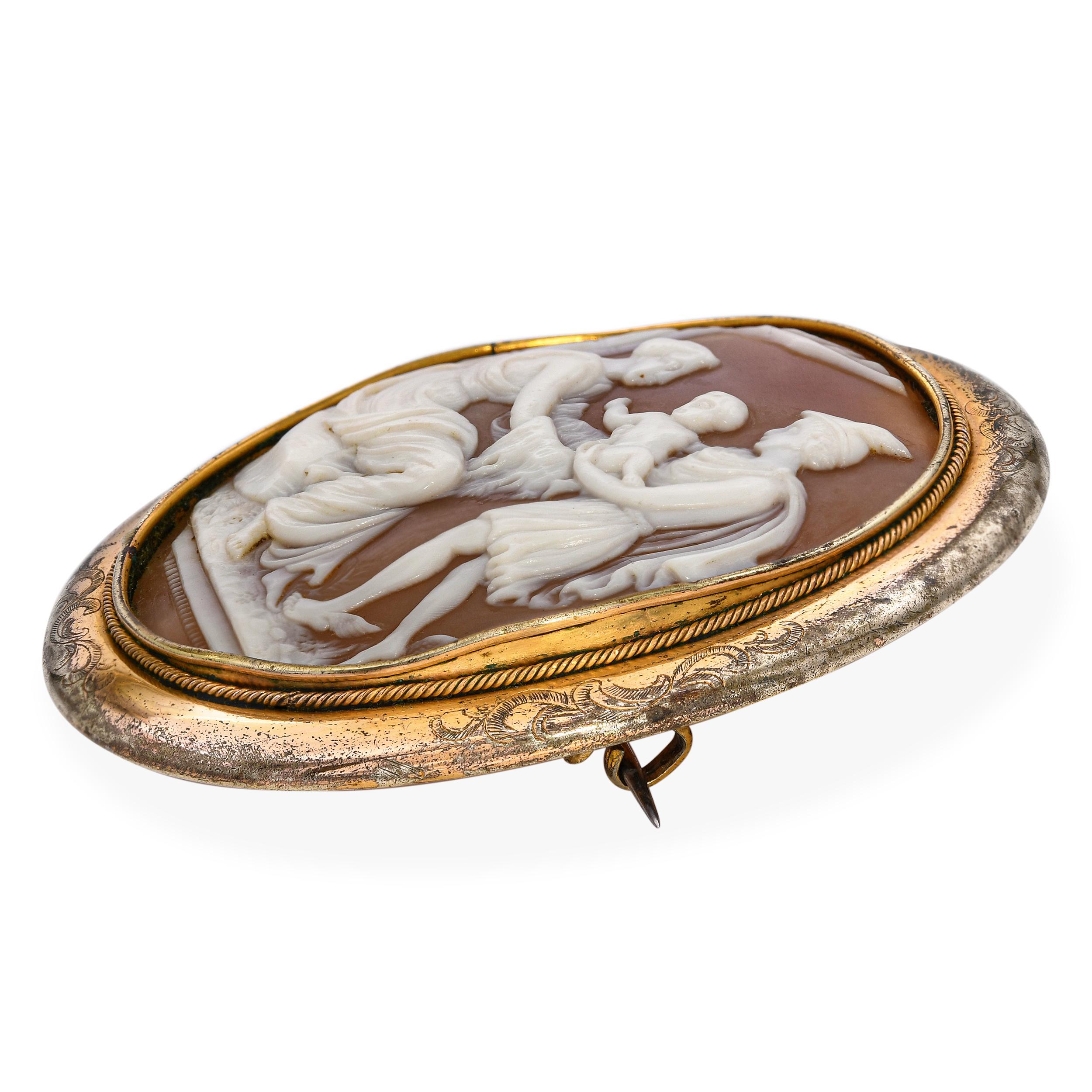 This finely carved antique shell cameo depicts the mythological scene of Mercury Presenting an Infant, rendered in exquisite high relief. Mercury, identifiable by his winged helmet, gracefully offers the child forward while a seated woman receives