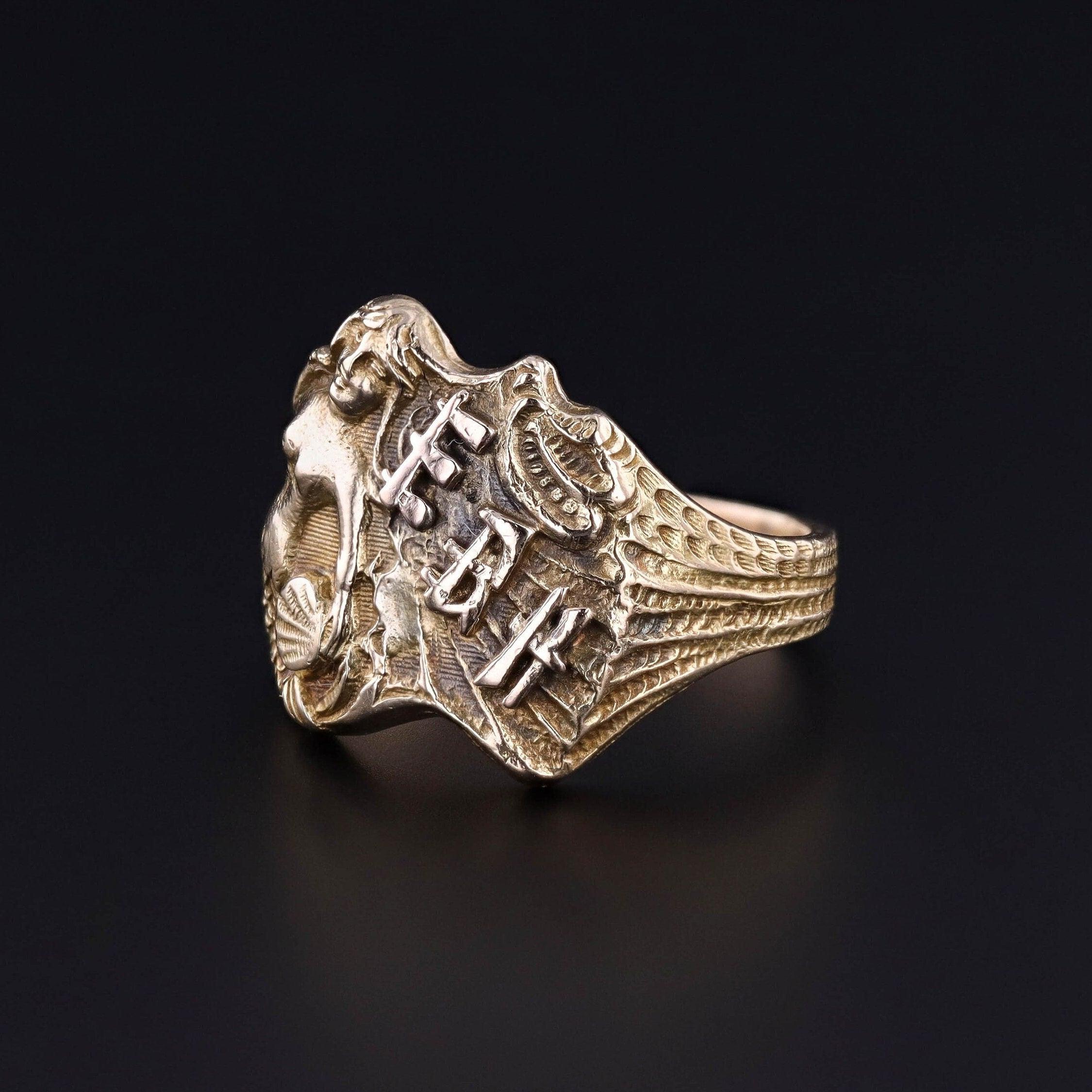 Antique Mermaid Ring: This 14k gold Art Nouveau era ring (circa 1910-1920) features a mermaid holding a shell alongside the initials 'EBH.'

The face of the ring measures 0.75 inches at its widest point. The ring is currently a size 10 and in great
