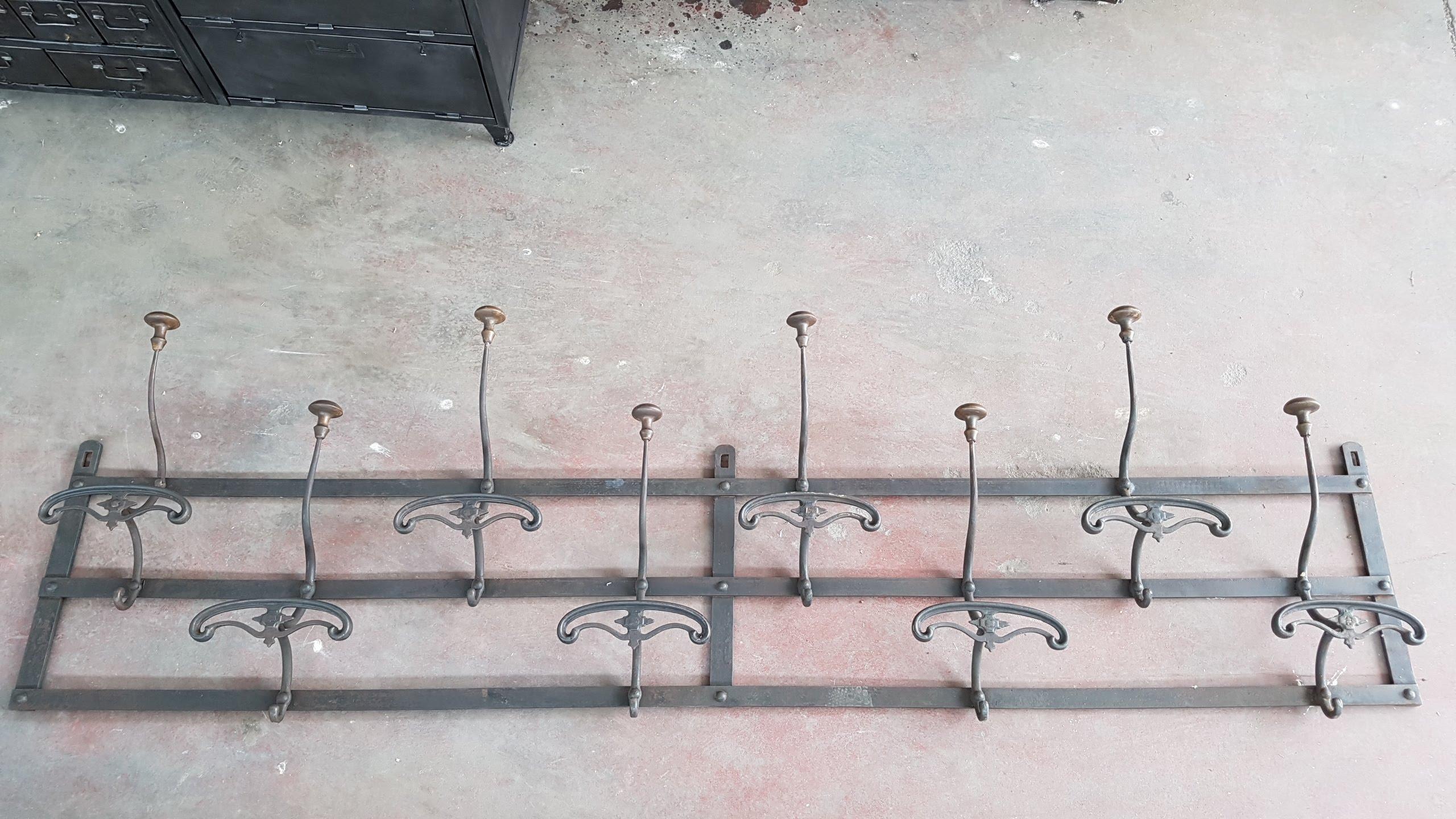 This rare and very antique coat rack with 8 hanger is very fascinating and comes from Piedmont, Italy where it was originally used in a school of the late 1800. It is all made by iron, perfectly preserved and restored, on the surface it has been