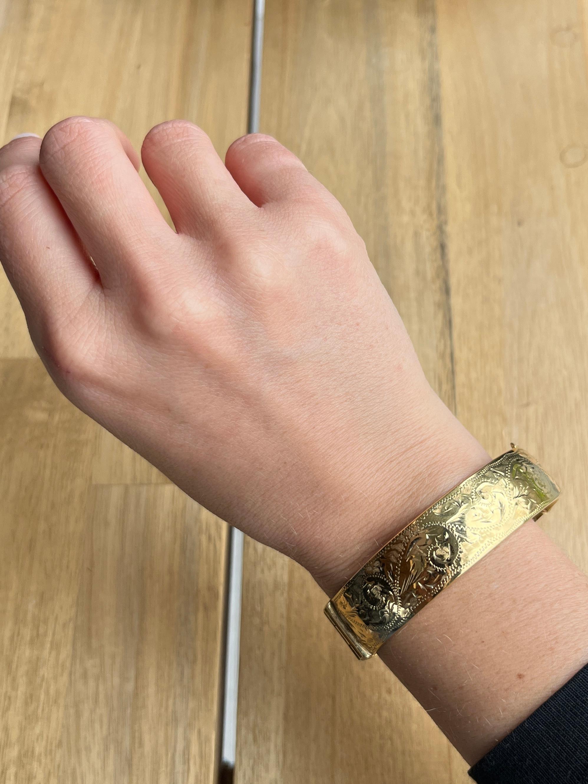 This gorgeous metal core bangle has wonderful engraving and is coated in 9ct gold. 

Inner diameter widest point: 6.1cm
Inner circumference:  17.2cm
Bangle Width: 16mm

Weight: 31g