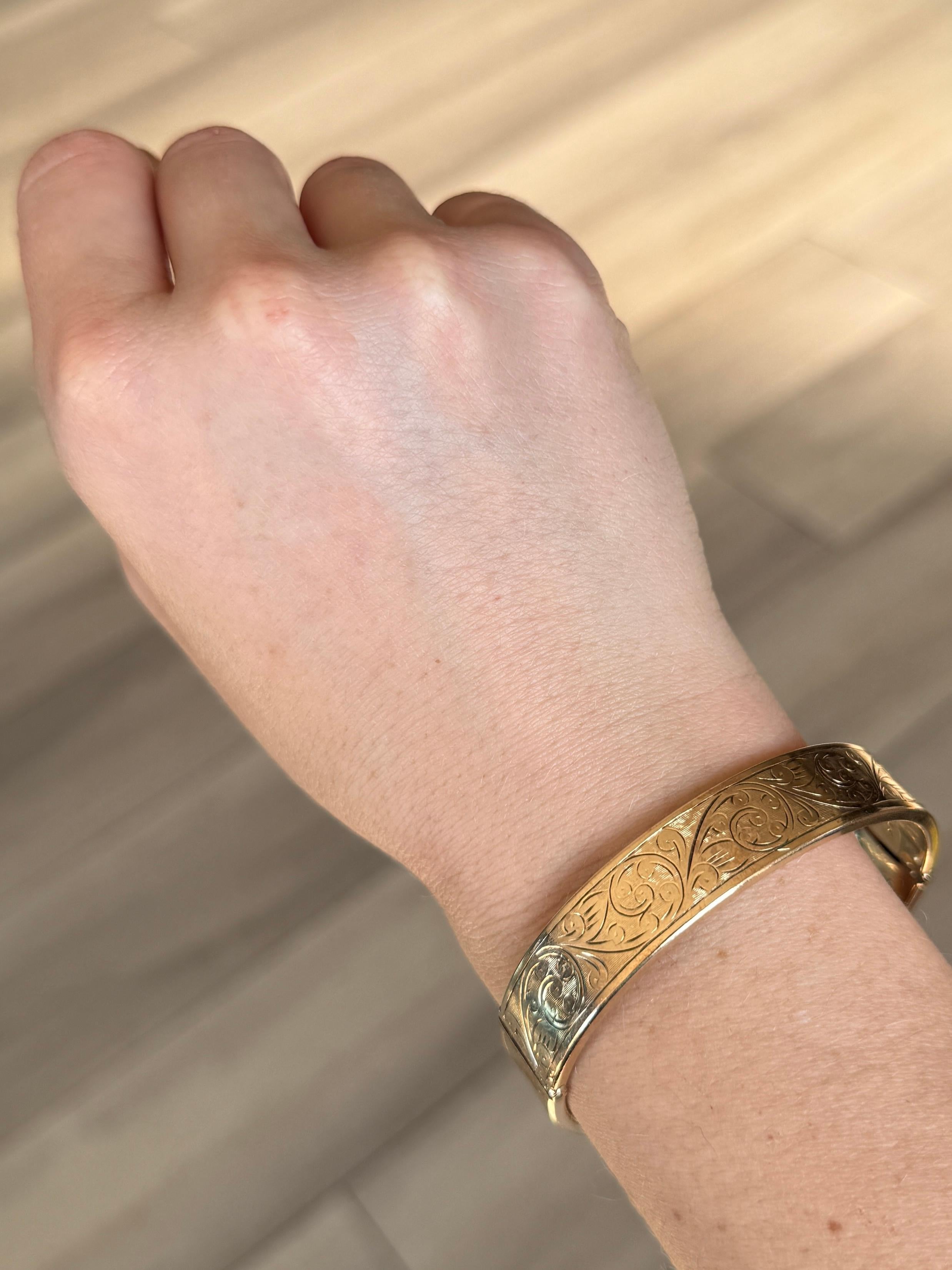 This gorgeous metal core bangle has wonderful engraving and is coated in 9ct gold. 

Inner diameter widest point: 6cm
Inner circumference:  17.2cm
Bangle Width: 12.5mm

Weight: 22.4g